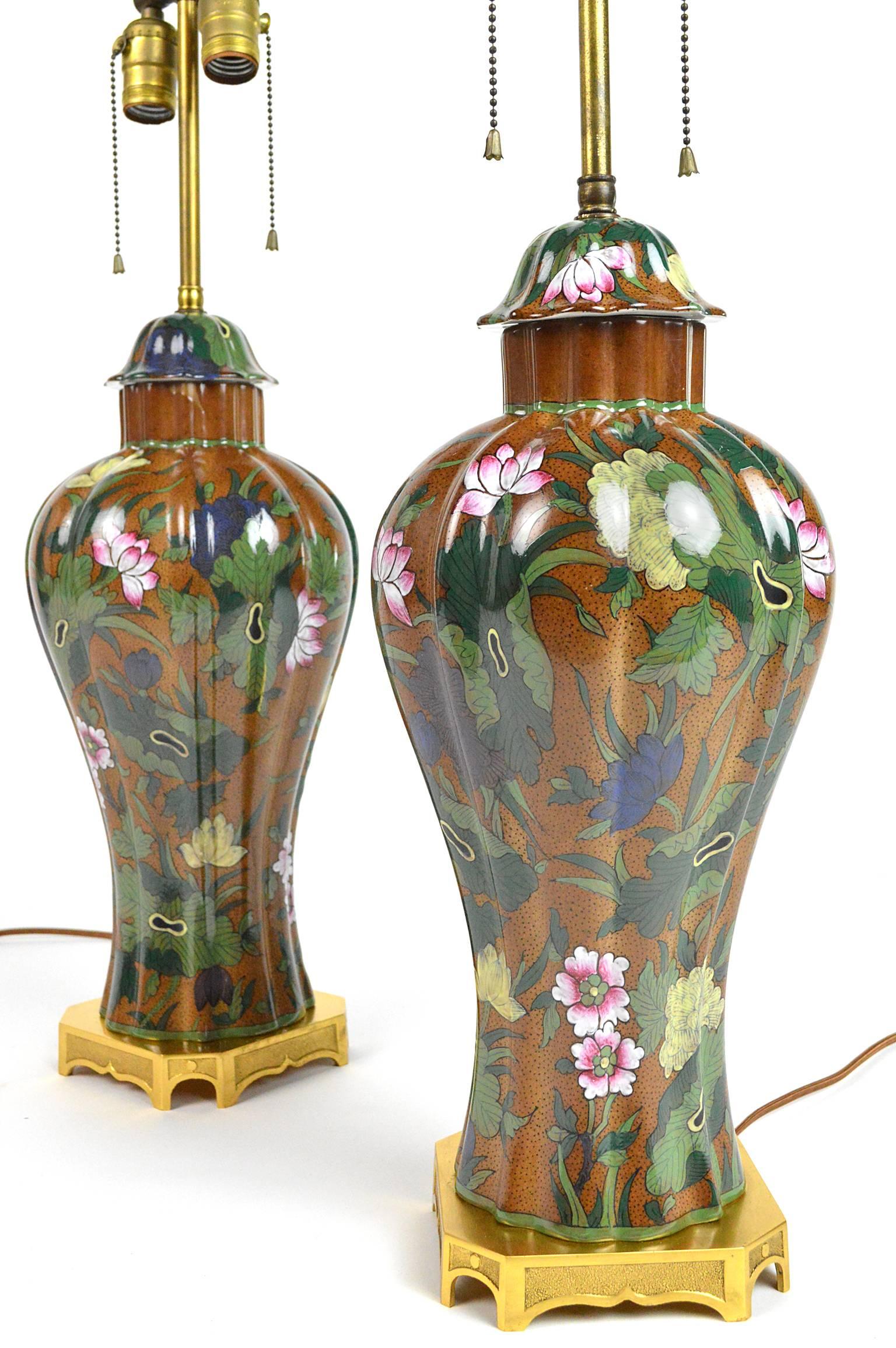 Pair of hand-painted French ginger jar form porcelain table lamps with floral decor each mounted on a gilt bronze base.
25.5