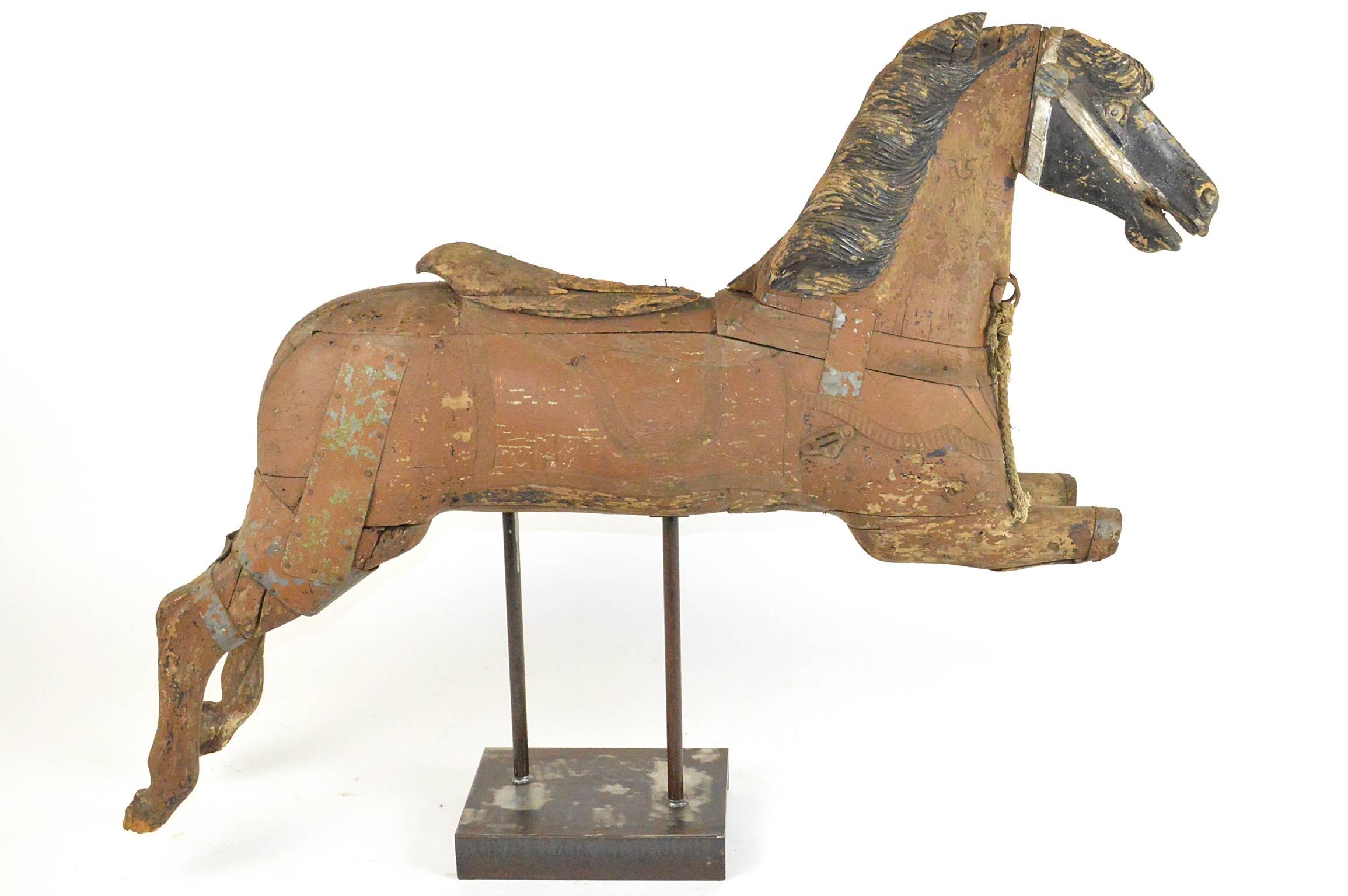 Late 19th century carousel horse nicely carved and mounted on custom stand with traces of original paint and accents.
