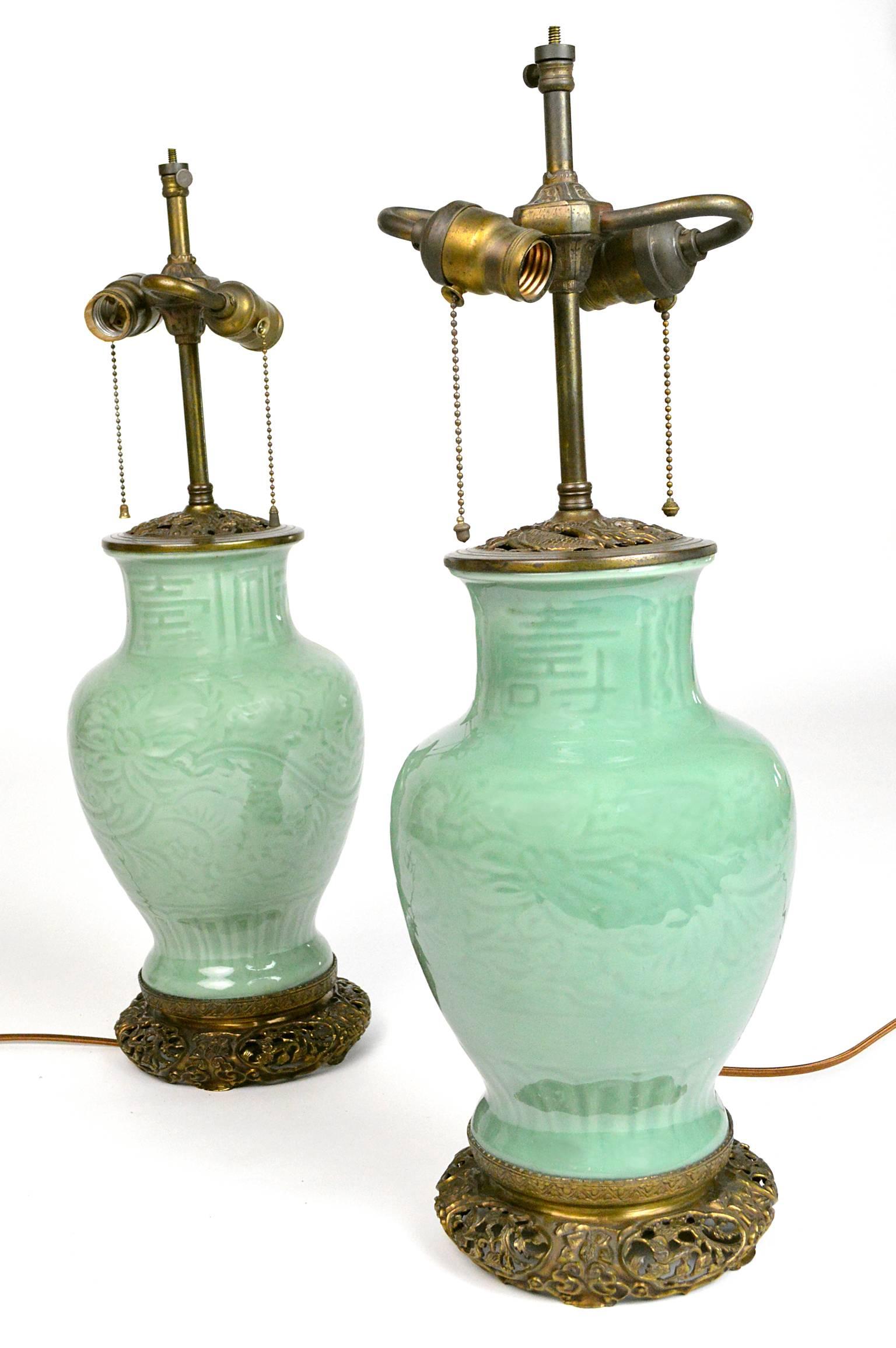 Pair of Chinese celadon porcelain lamps, each with original gilt bronze bases and fittings. Newly rewired. Absolutely gorgeous color. 20