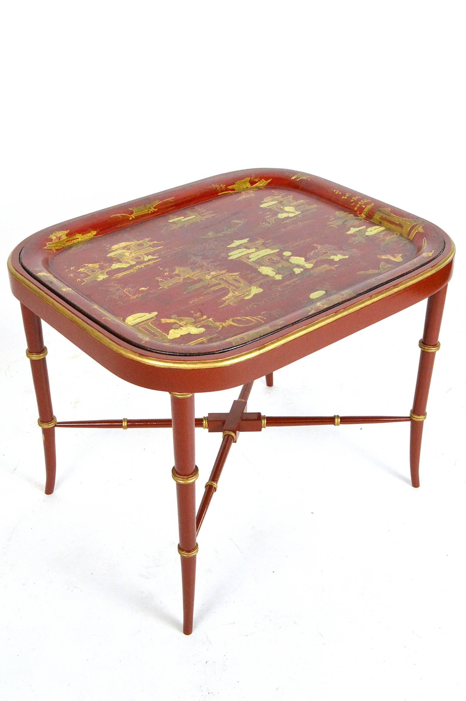 19th century red chinoiserie tray table. Stand having faux bamboo decoration. Tray depicting Asian motif. Absolutely stunning color combination.