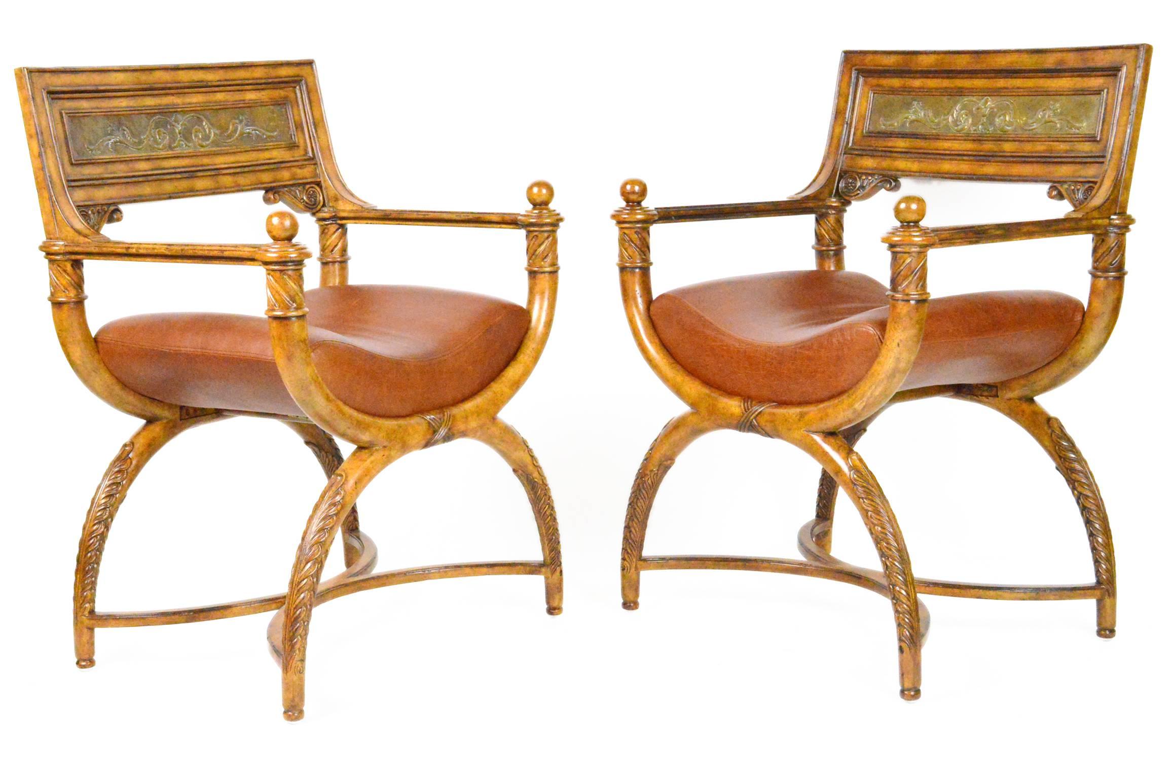 Pair of Savonarola style chairs with distressed pine finish, inset metal relief back plaque and leather upholstery.
Measures: 26.25