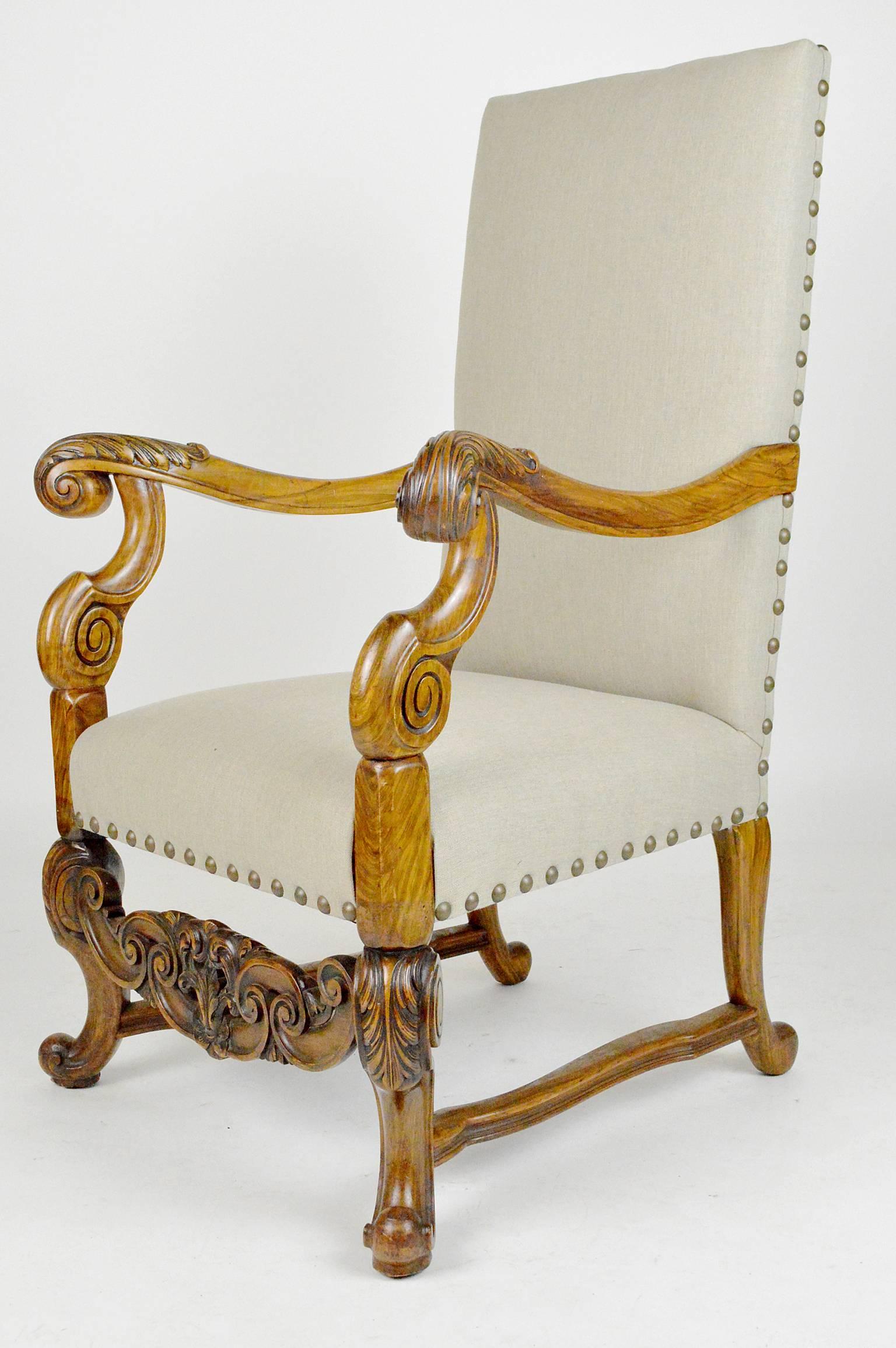 Renaissance revival style carved walnut armchair with lined upholstery.