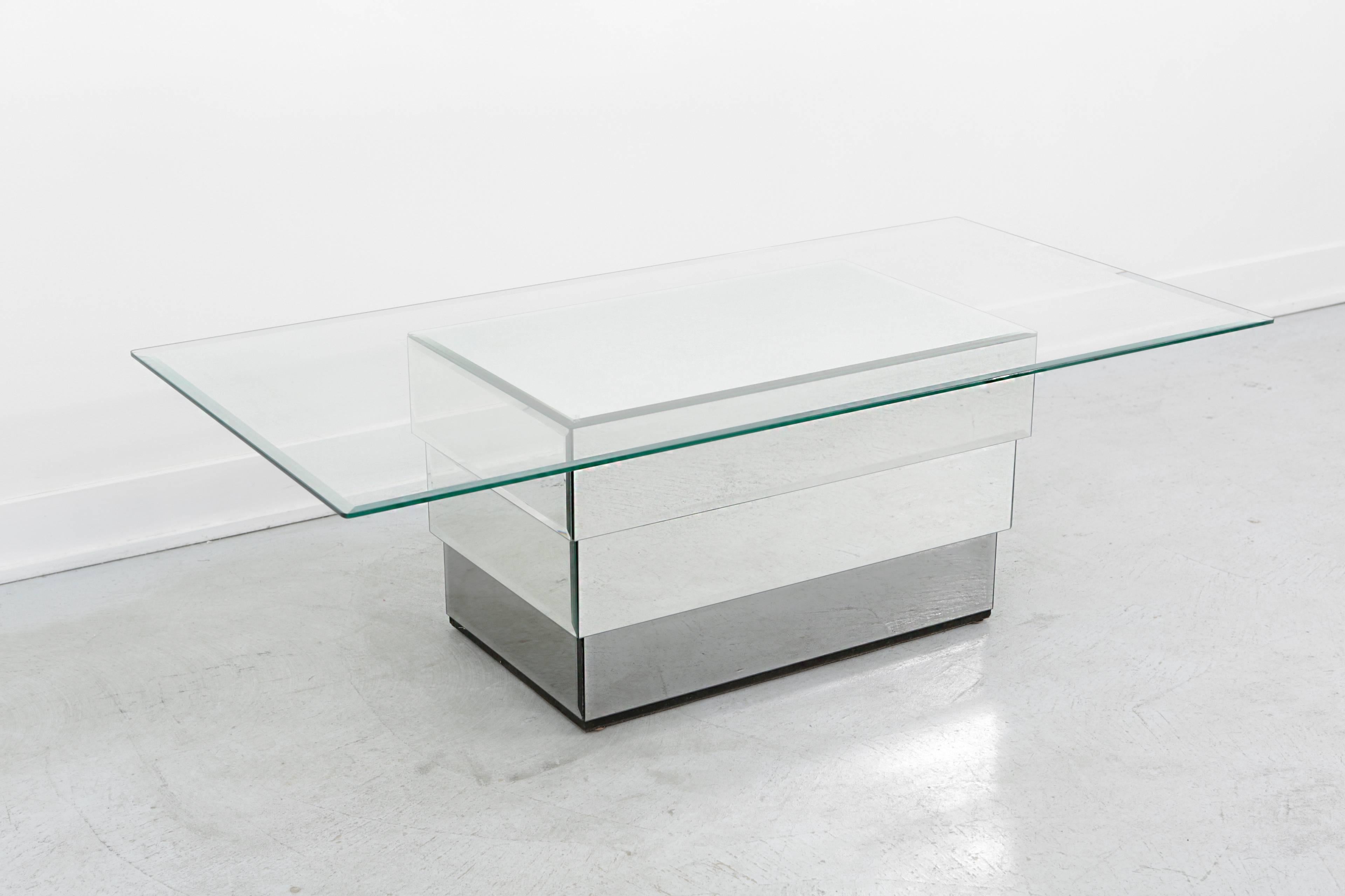 Ello glass and mirrored coffee table. A rare cocktail - coffee table with a mirrored base that is tiered and a beveled glass top.