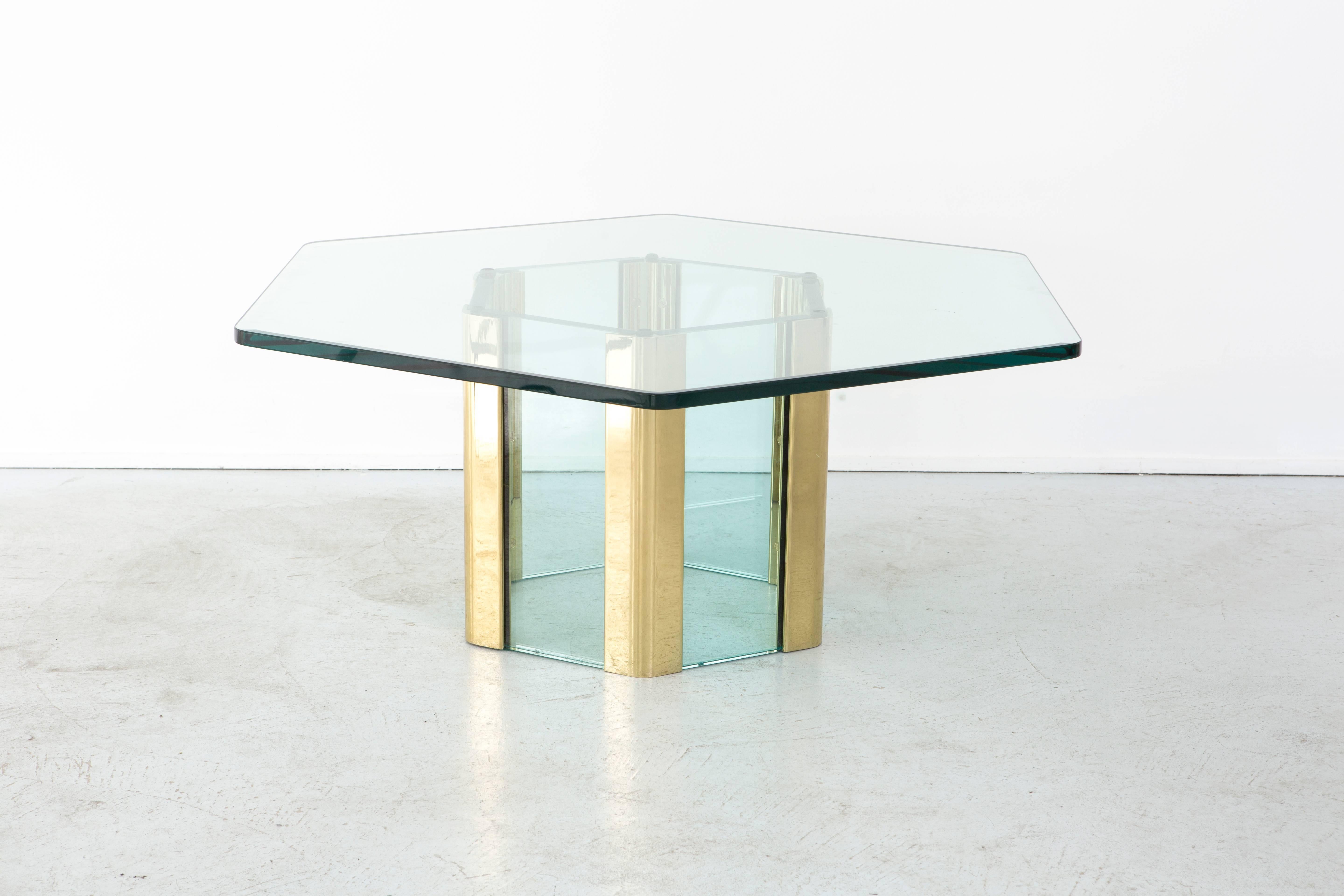 Hollywood Regency style glass and brass cocktail - coffee table in a unique hexagon shape, designed by Pace Manufacturing. This rare shape has a striking stance. Table is in excellent overall condition with no imperfections to the glass.