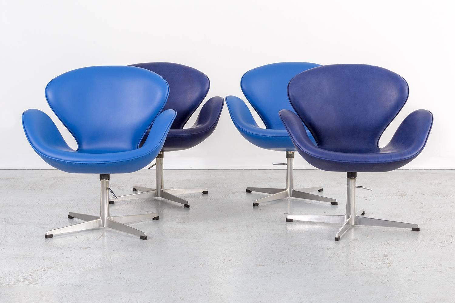Set of four swan chairs with labels intact 

designed by Arne Jacobsen for Fritz Hansen,

Denmark, circa 1959.

Reupholstered in leather with original aluminum bases

Highest adjustment point: 35 ½” H x 29 7/16” W x 26 9/16” D x seat 21 ½” H

Lowest