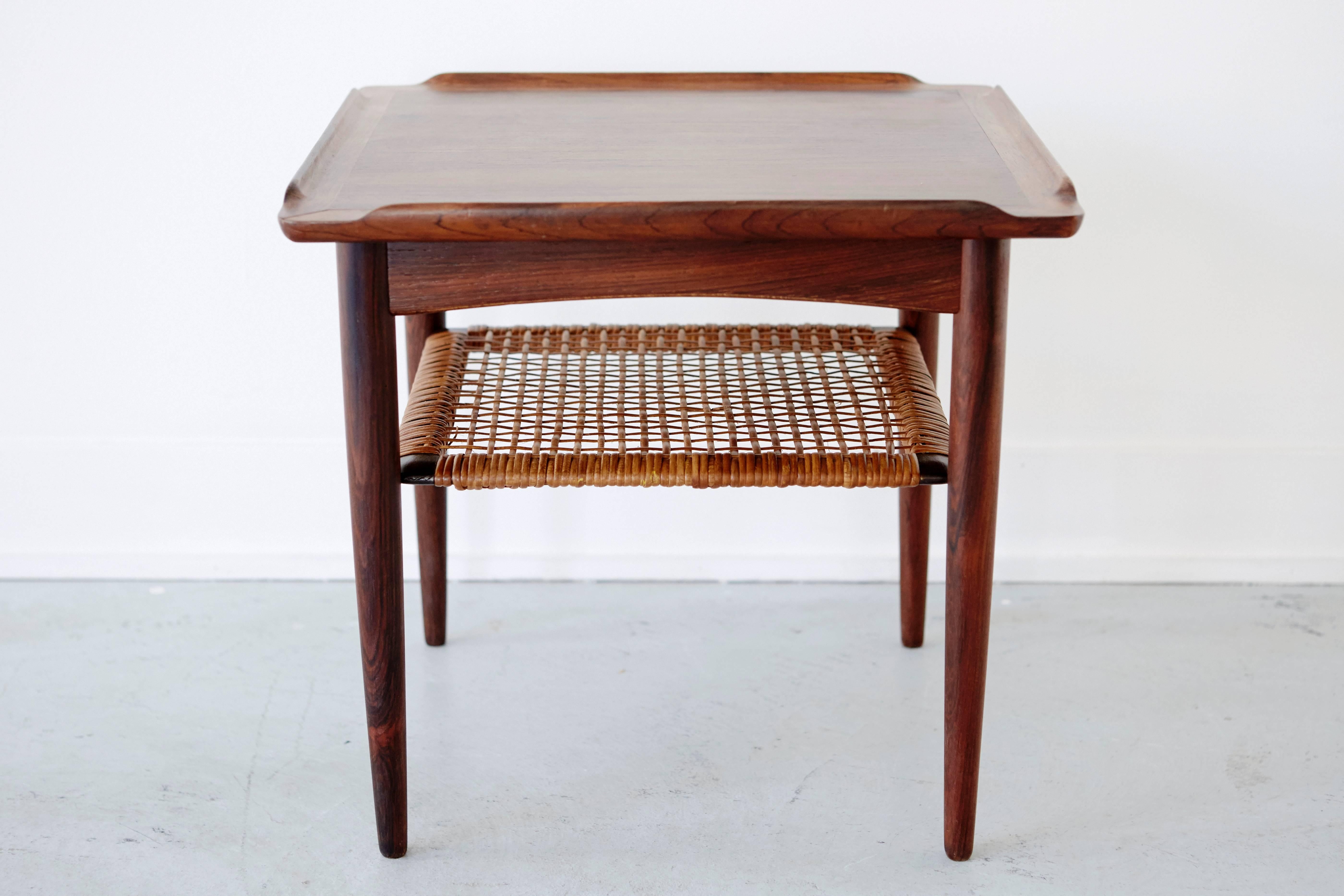 Rosewood and cane side table by Pouls Jensen for Selig. Excellent vintage condition with the Selig medallion intact on the underside.
