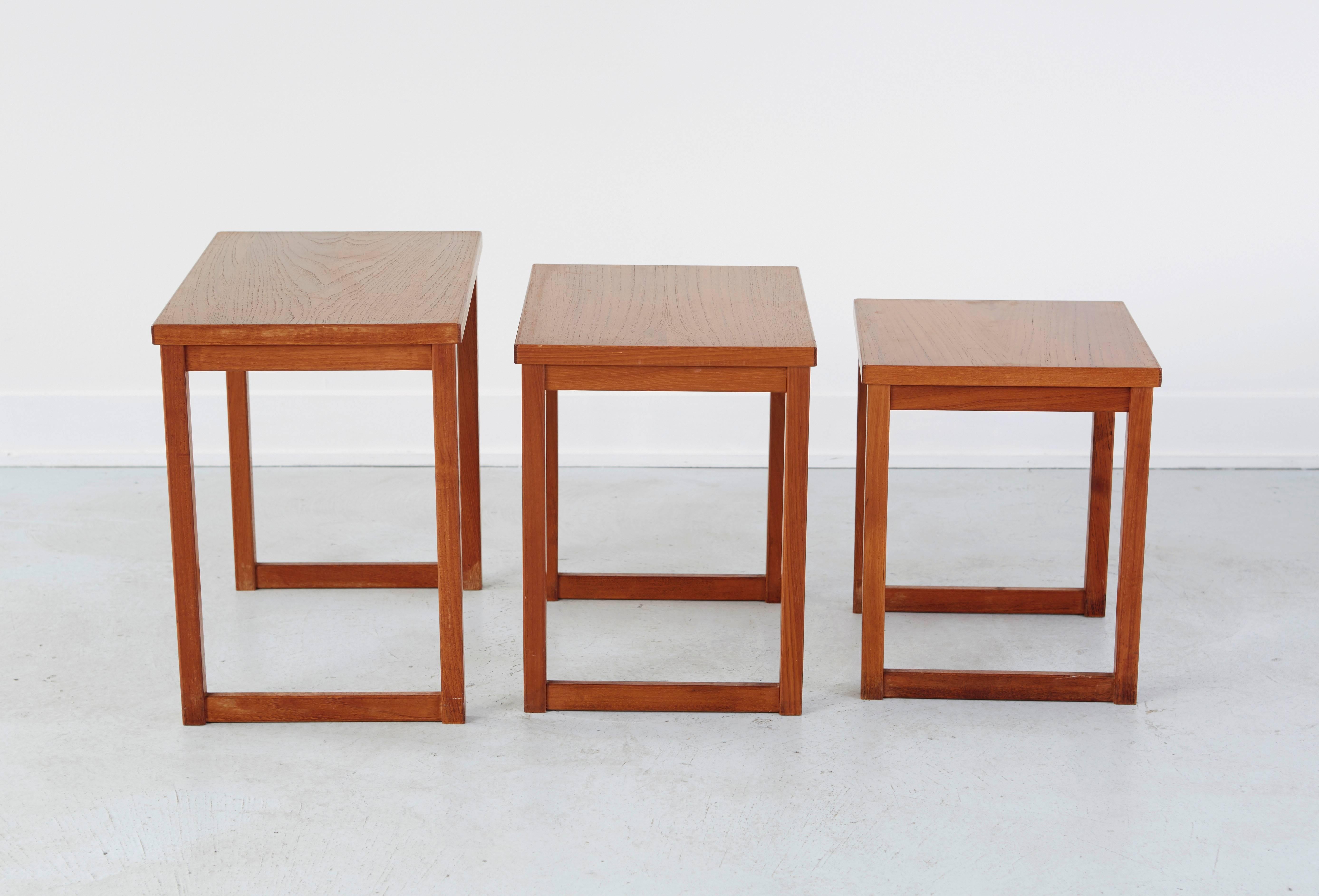 A set of three Kai Kristiansen nesting tables. Teakwood in excellent condition. Use as a coffee table, side table or nightstands. Measurement indicates largest of the three tables.