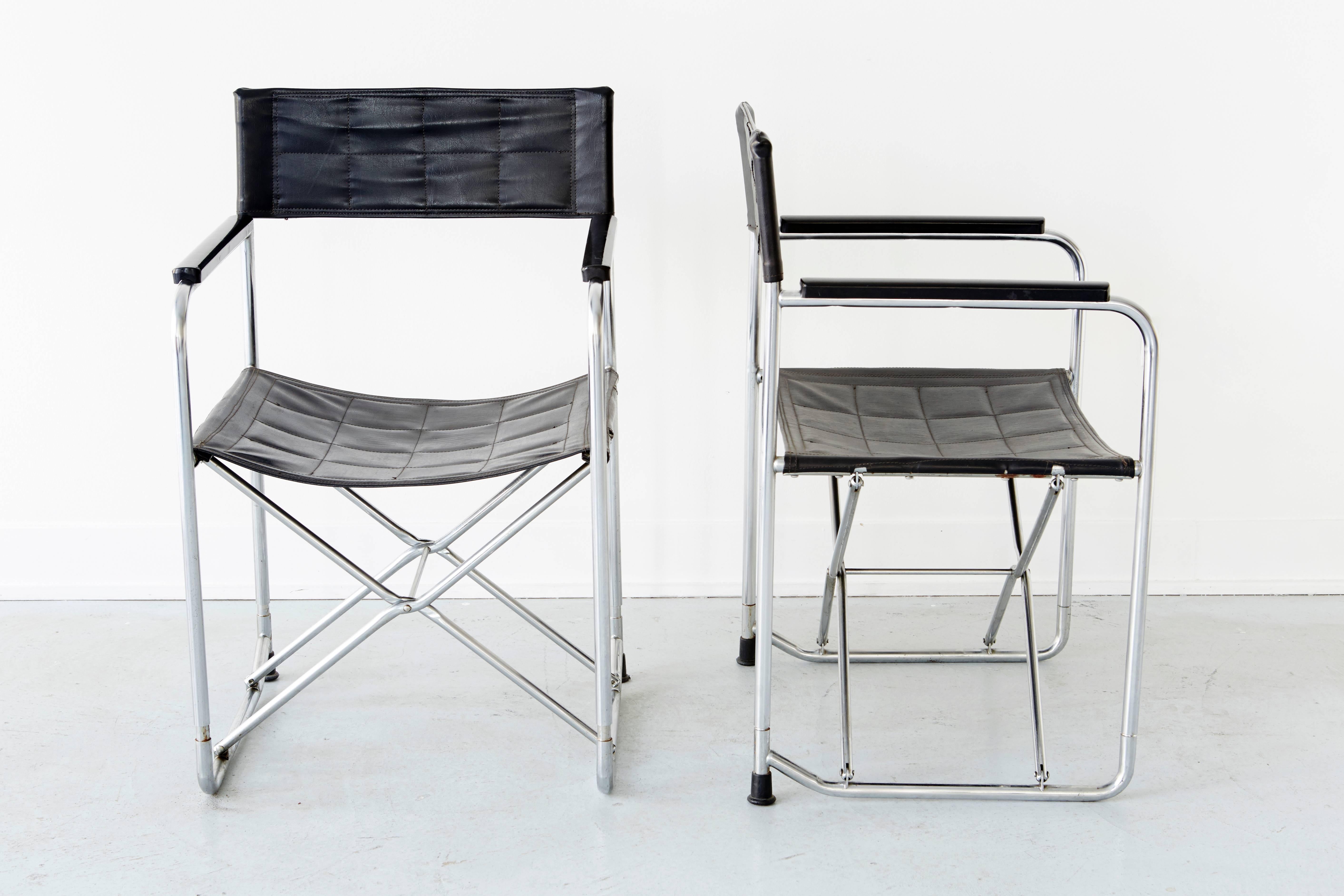 Pair of Japanese Uchida Mid-Century Folding Chairs.  These sleek vinyl and chrome folding chairs are in excellent overall condition.  