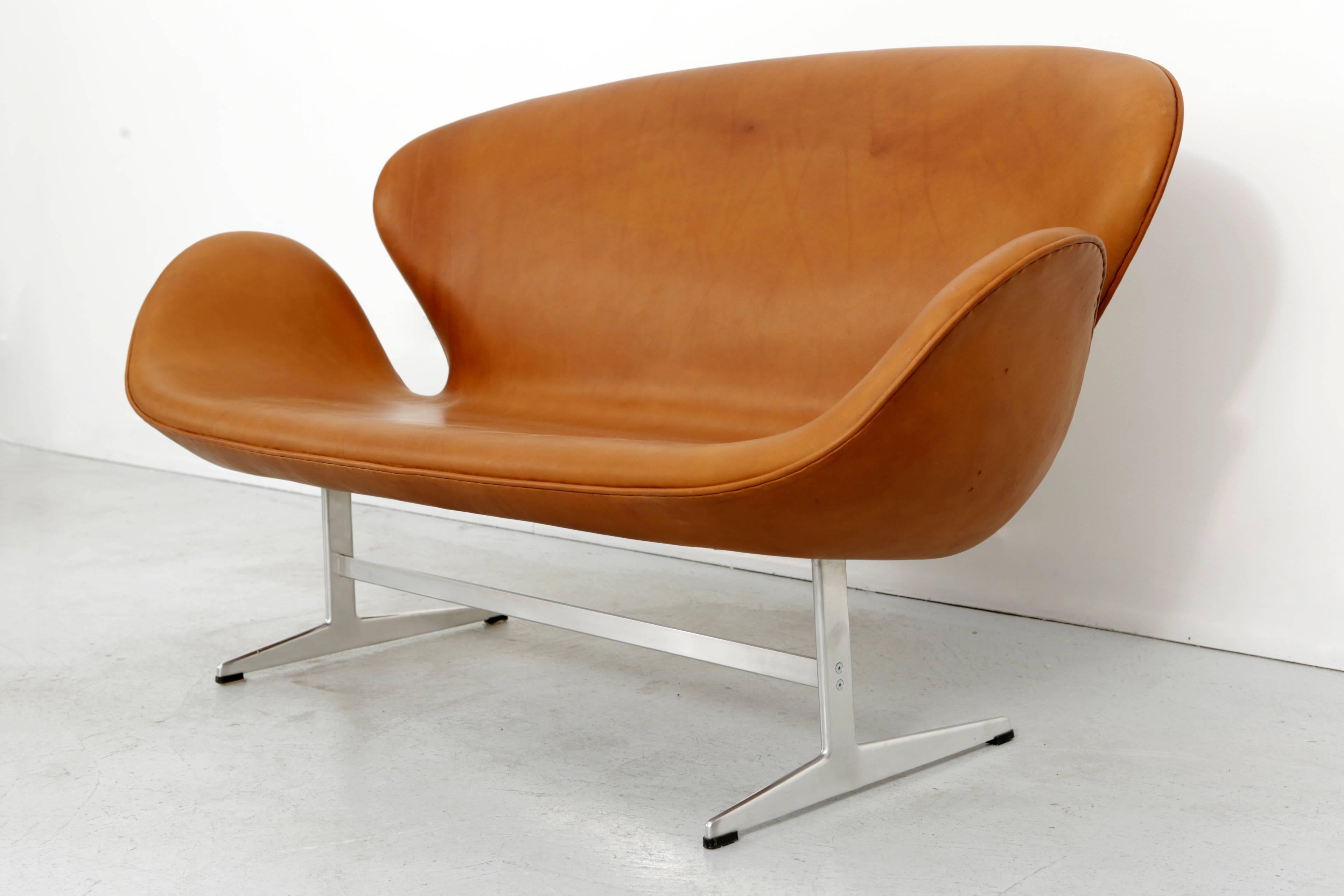 Arne Jacobsen Swan sofa (model 3320) for The Republic of Fritz Hansen reupholstered in cognac leather.  This iconic piece was originally designed for the SAS Royal Hotel in Copenhagen in 1958.   
