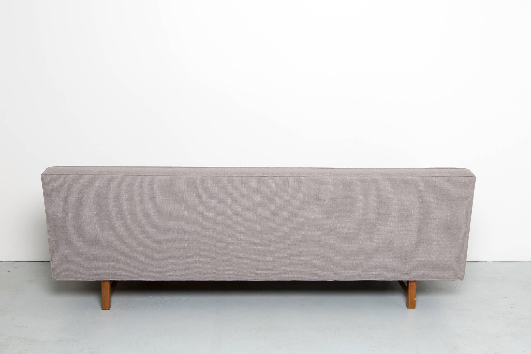 Sofa in the style of Ward Bennet reupholstered in a durable concrete grey.

USA, circa 1970s.

Reupholstered.

Measure: 82'' W x 32'' D x 28'' H x 18'' seat height.