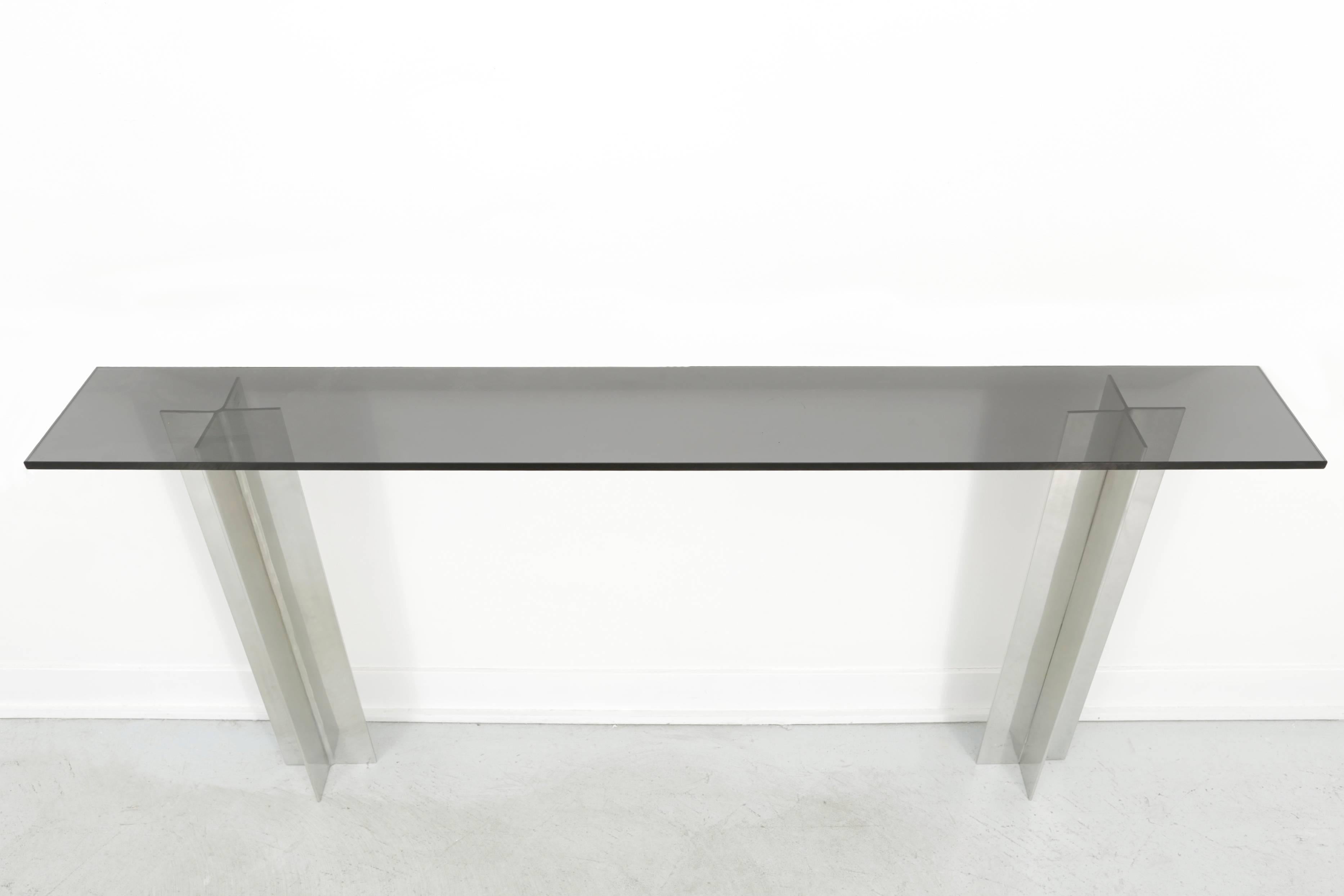 Console table

by Pace Manufacturing,

USA, circa 1960s.

Smoked glass and aluminum.

Measures: 28 ½