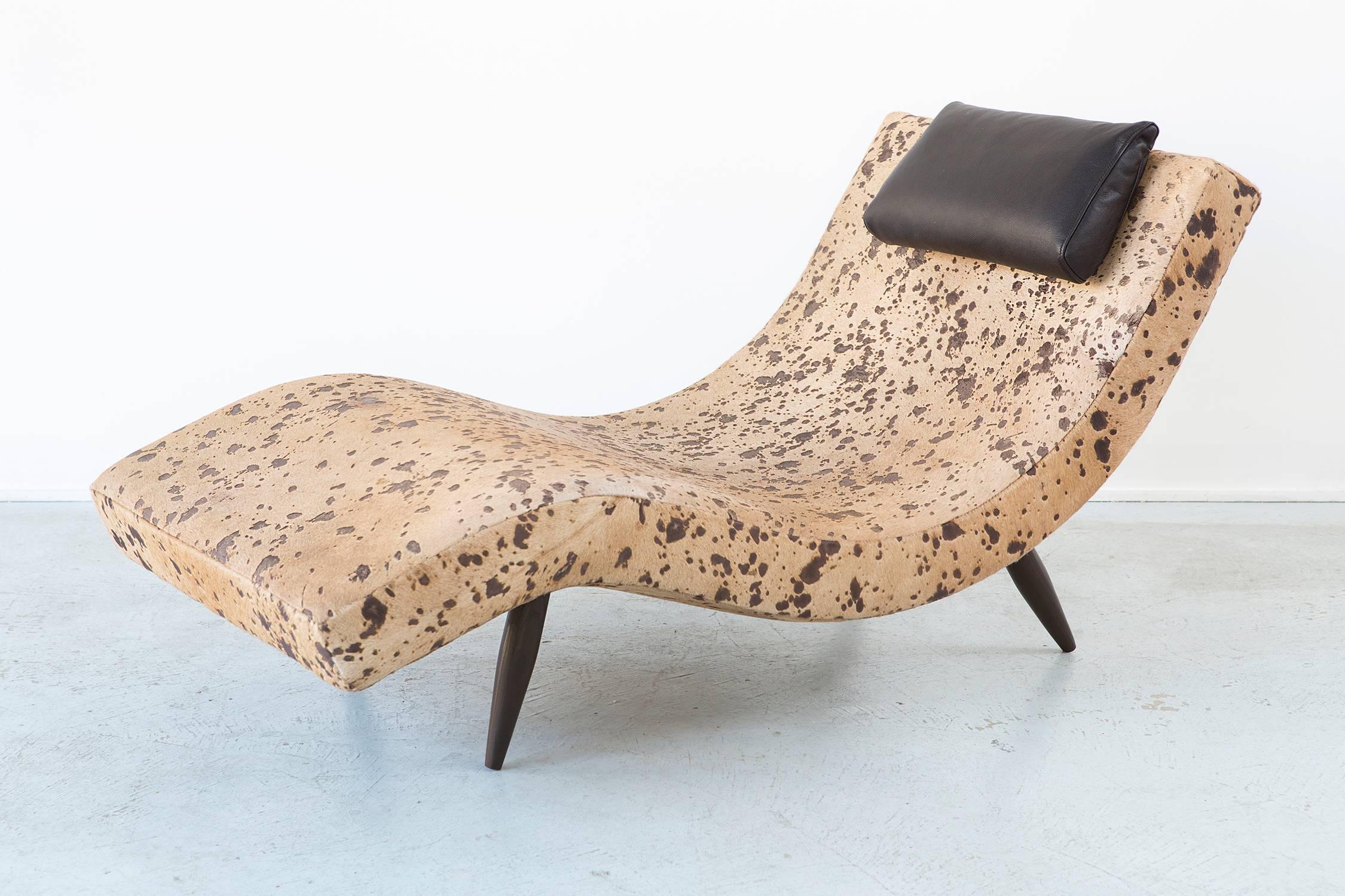 This Adrian Pearsall wave chaise is the more obscure singular version   recovered in a unique one-off acid treated cowhide that holds inviting earth tones.

Adrian Pearsall was known for his flamboyant and extravagant designs that have stood the