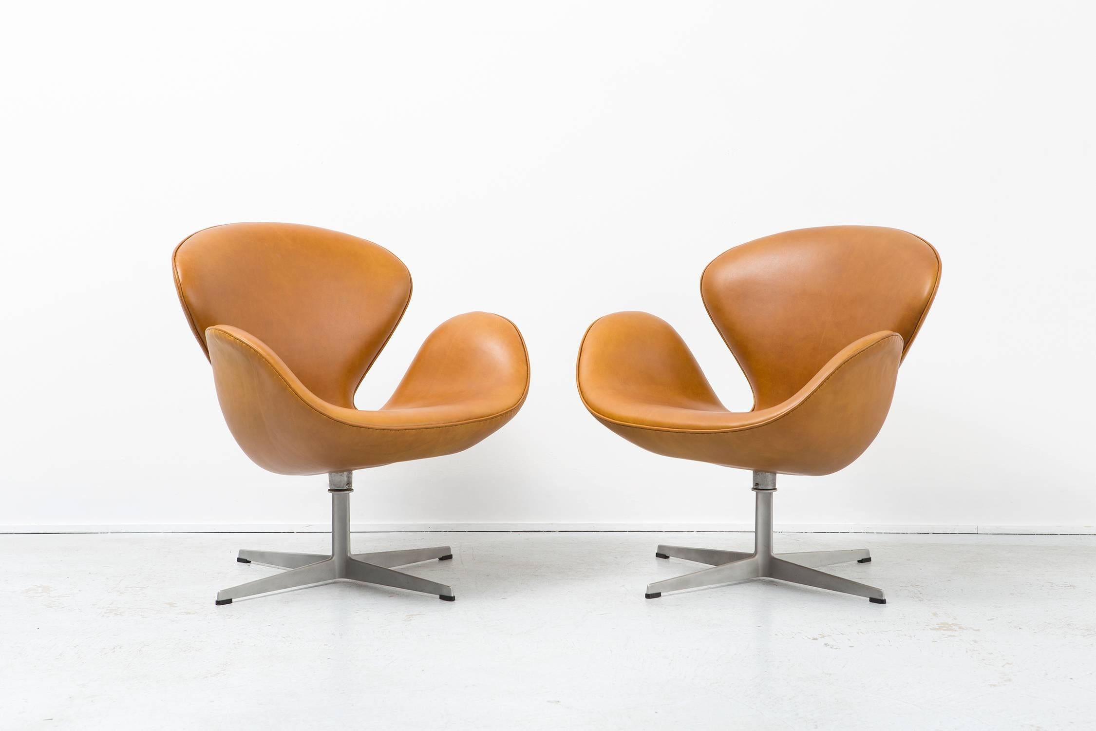 Set of two swan chairs

Designed by Arne Jacobsen for Fritz Hansen

Denmark, 1958

Reupholstered in congac leather

Measures: 29 ⅞" H x 29 ½" W x 26" D x seat 15 ⅜" H

First designed for the Radisson SAS Royal Hotel in