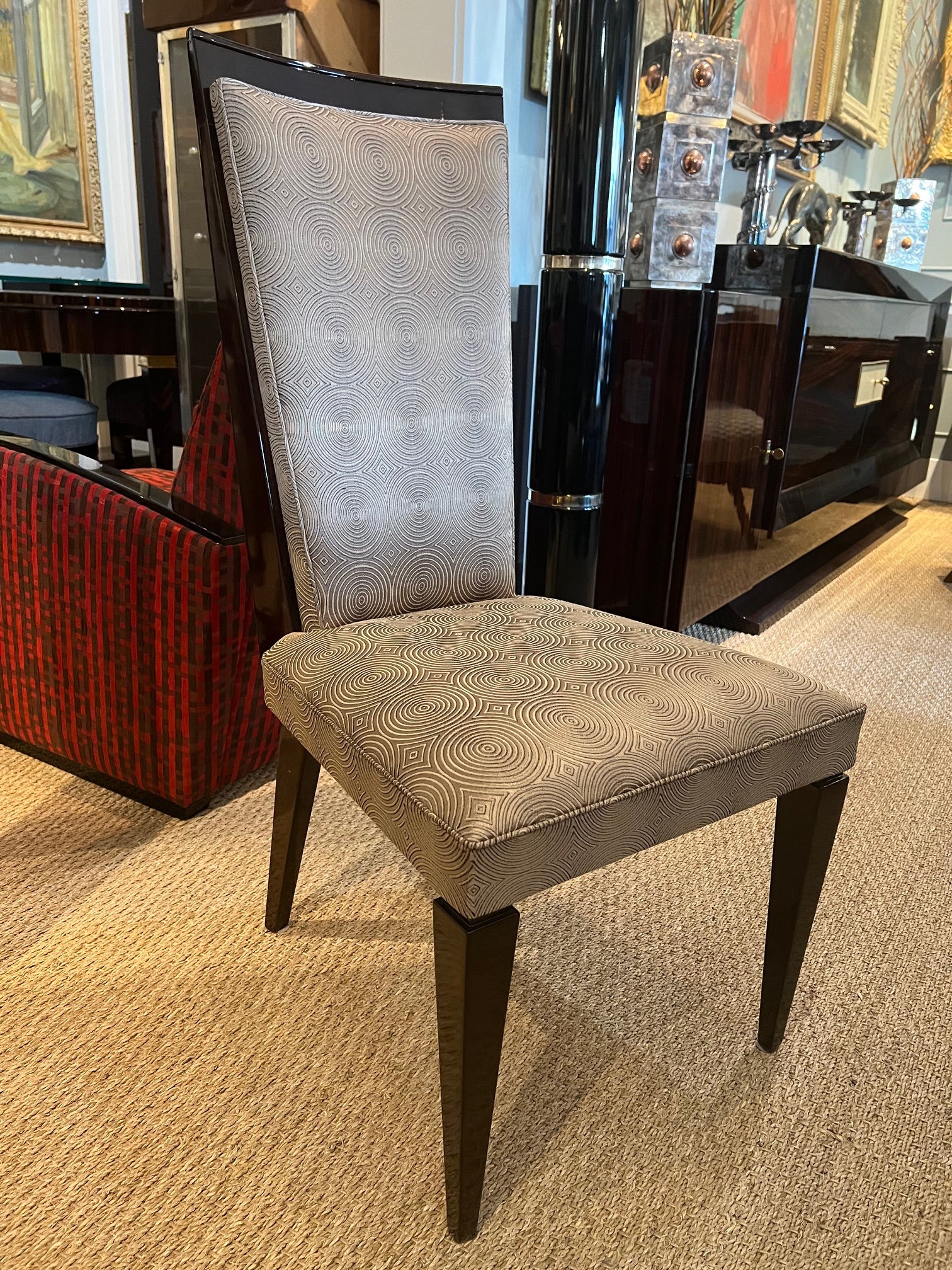 The full set of 8 dining room chairs from Art Deco period. Made from walnut wood and newly re-upholstered with light grey fabric with circular pattern. Chairs have high back and stable supporting legs. 
 France, c. 1930s
Condition is perfect.