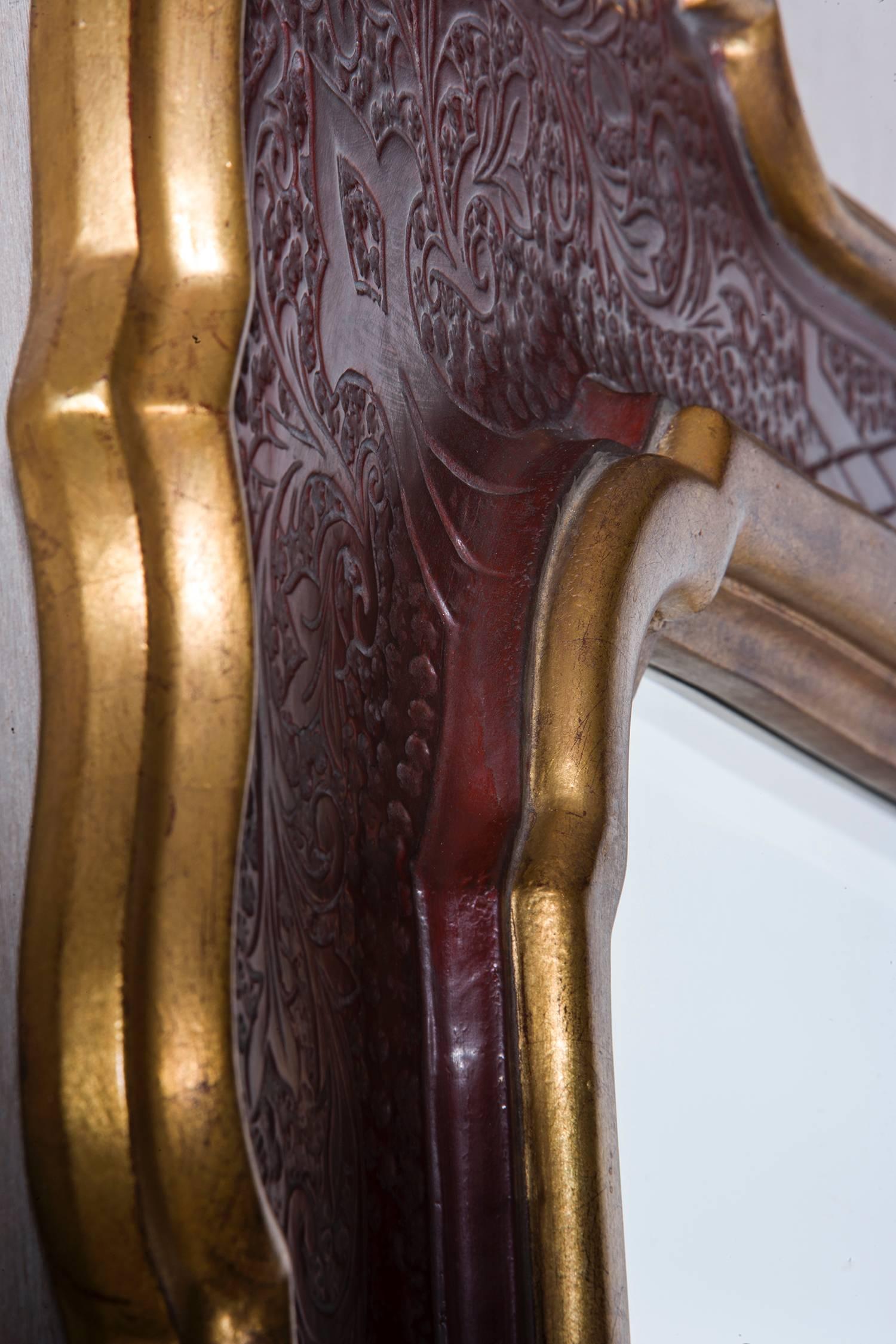 Spanish mirror with incised carving in border.
Gold gilt border and inner rim border
Clear shaped beveled original mirror.
Carved inner detail with clay red finish
Measure: H. 53