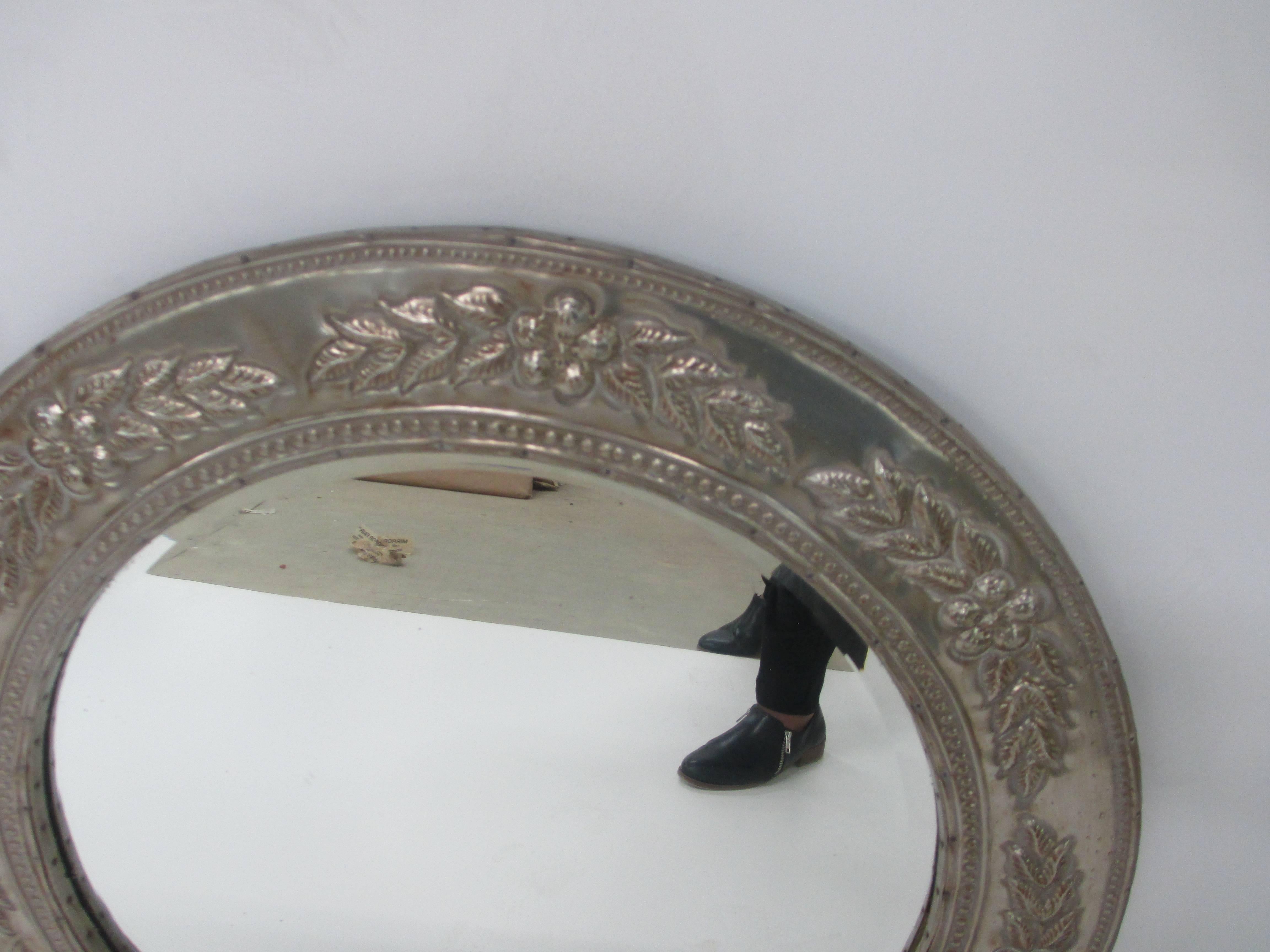 Round metal-clad mirror. 
28