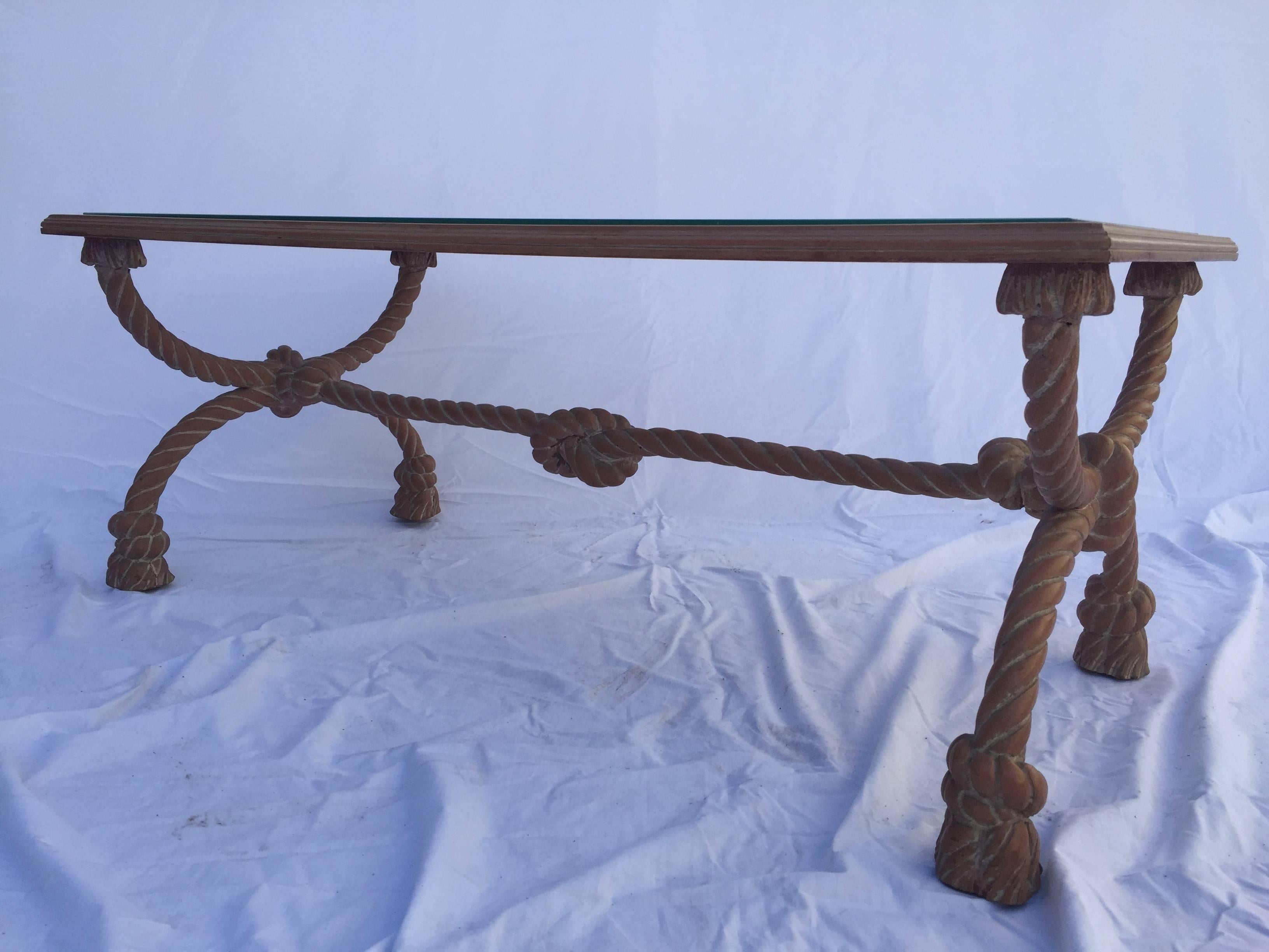With carved wood rope, knot and tassel design, the clear and strip mirrored inset looks to float above the 'rope' support. The top has mirror strips where the supports of the table are so as to cover them. One foot is missing a small piece where the