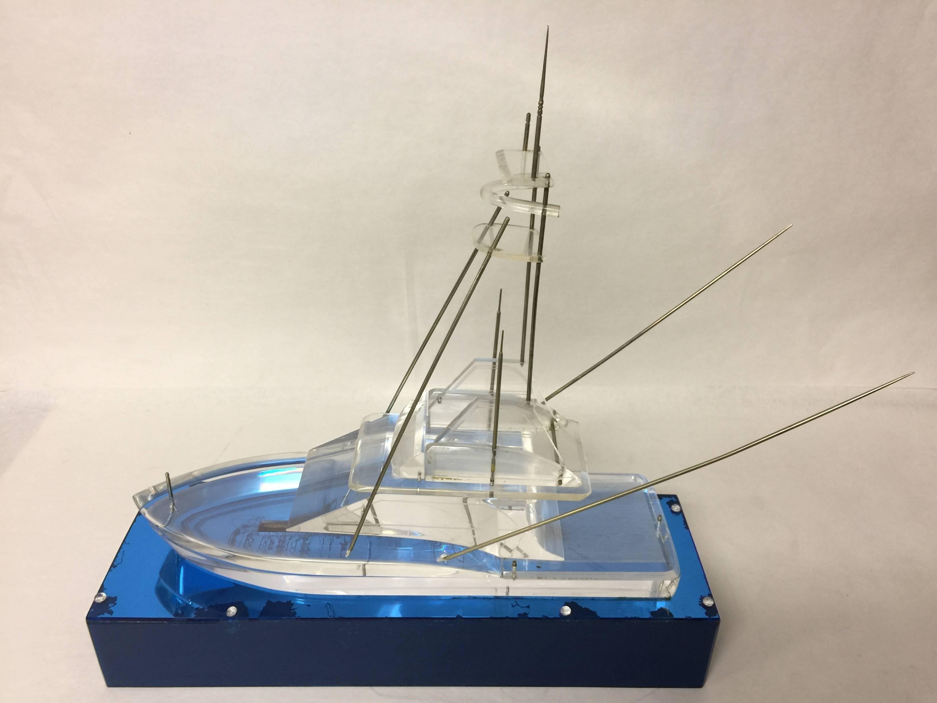 Ready to reel in the big one? Here it is. This vintage Lucite deep sea fishing boat model sits atop a blue Lucite base. Ahoy. The base measures: 20
