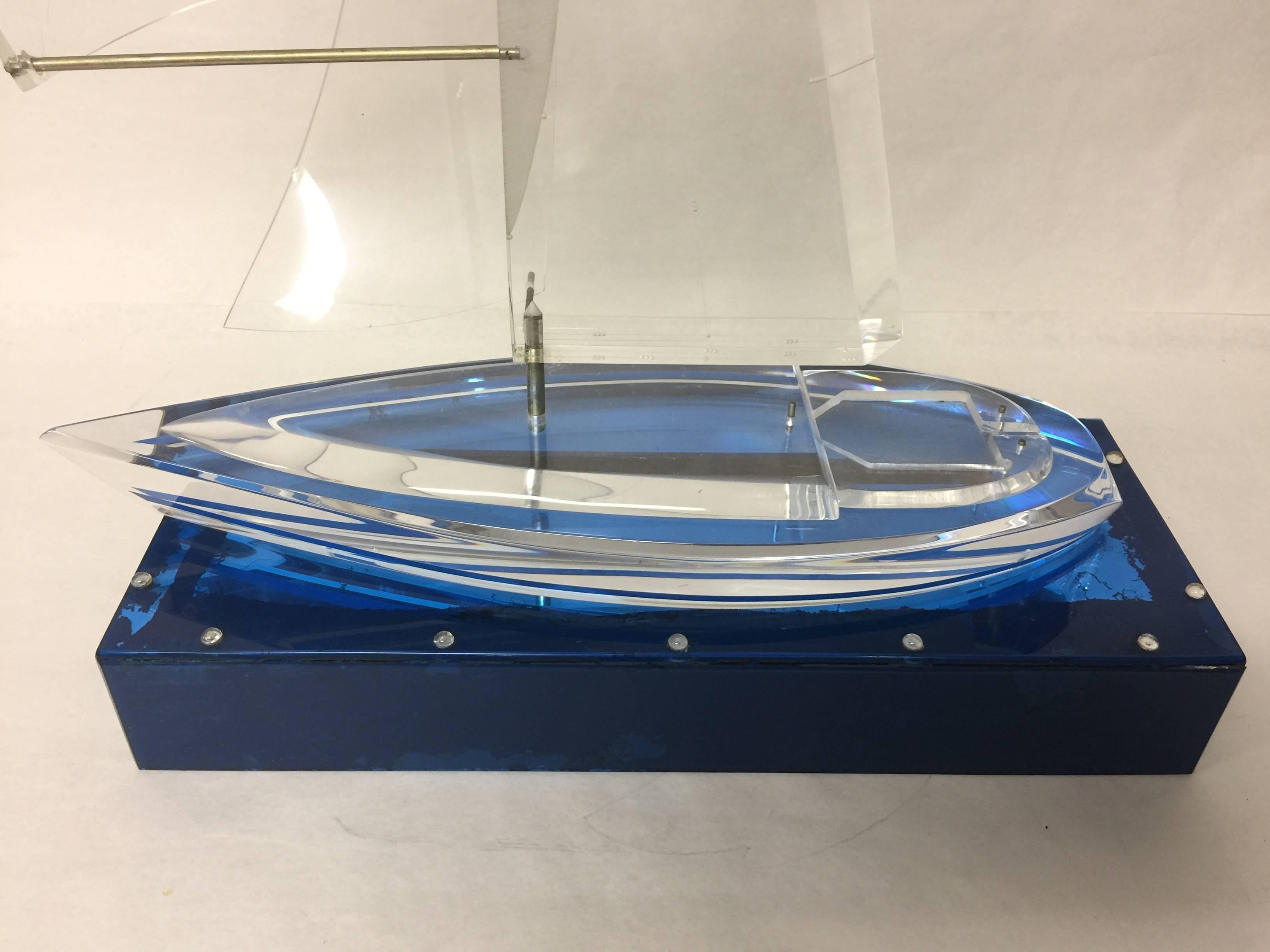 Ahoy matey, lower the boom, raise the sails. No, I'm not a sailor, but I can look like one with this vintage Lucite racing and sailing yacht model on a blue Lucite base. Oh, and it illuminates too. The base measures: 19.5