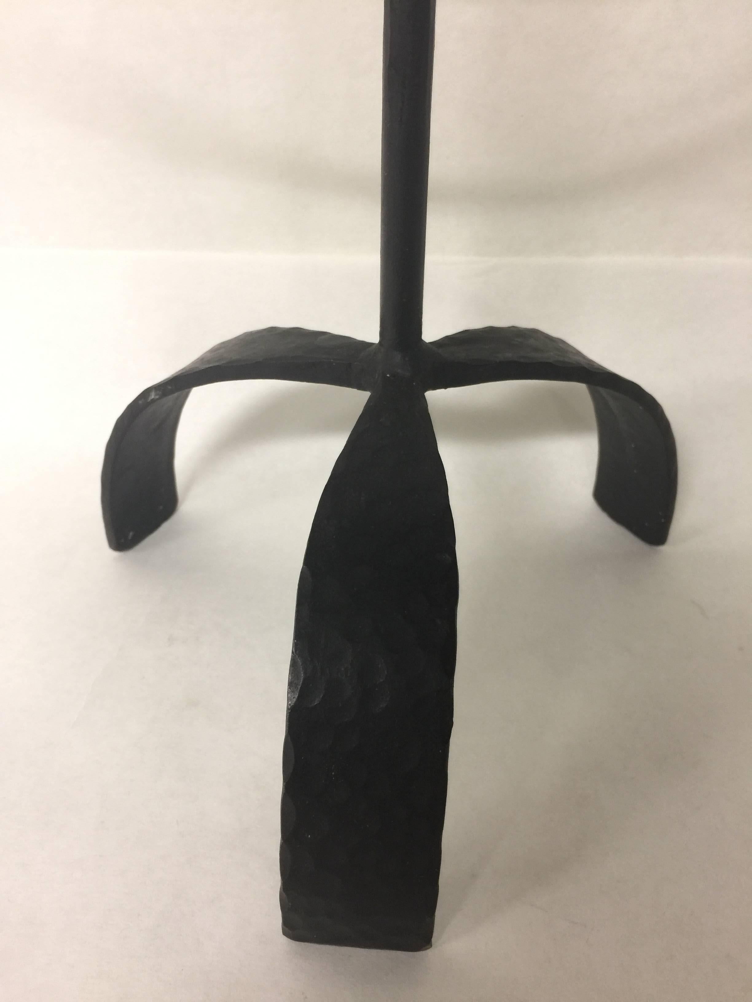 Stamped made in Sweden, this vintage candlestick holder is forged from iron and sits on a tripod base. Holds seven candles.
