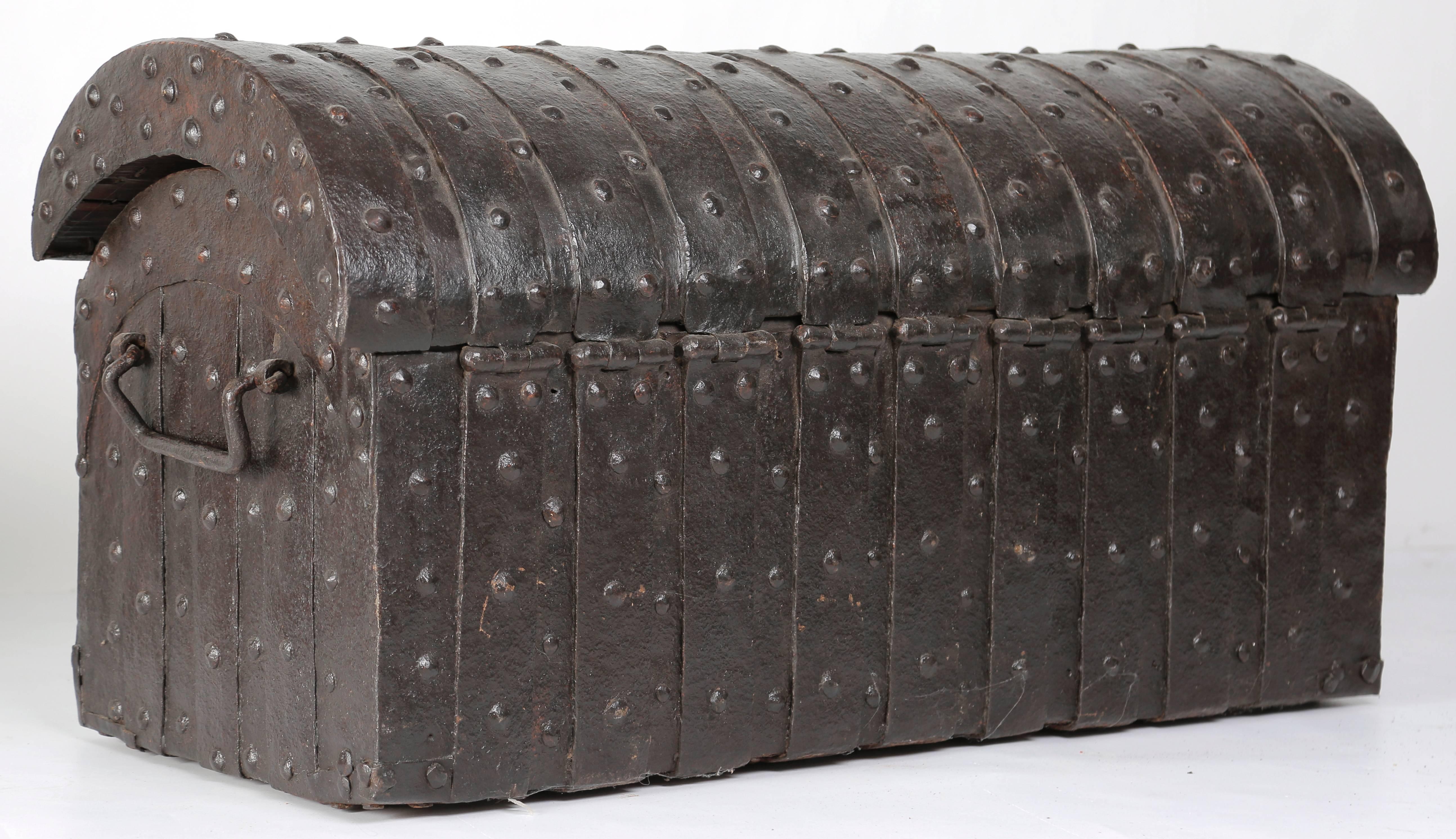 An extremely rare late 14th-early 15th century medieval oak iron bound round topped parish chest (officially: Kist der Barmhartigheid; Chest of mercy), the Southern Netherlands, circa. 1390-1430. 

The entire length of the chest is clad with