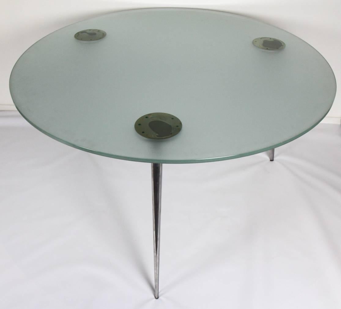 A handsome dining table "M Serie Lang" with frosted glass top on three aluminum legs, design Philippe Starck, 1985. Produced by Aleph/Driade, Italy. Table is marked in each cast aluminium leg: Aleph by Starck

Condition: