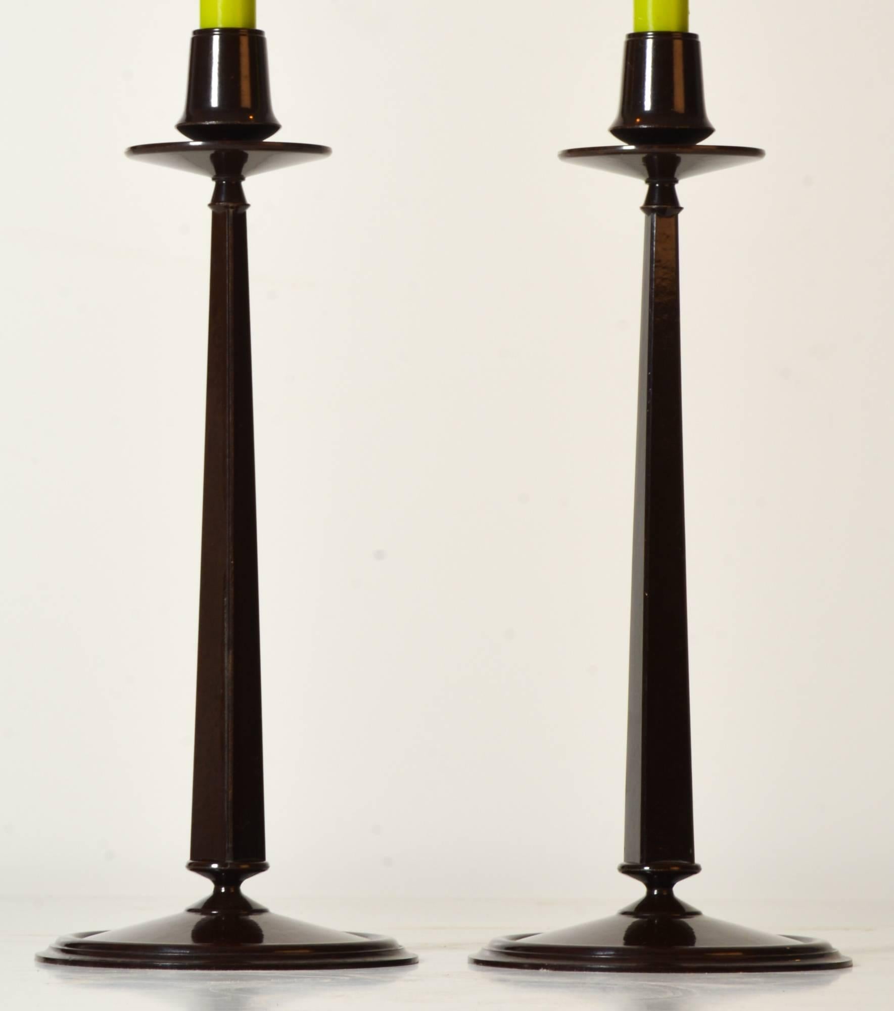 A fine pair of Jugendstil tall tapered elegant backelite candlesticks, designed by Charles Rennie Mackintosh and manufactured by Linsden Ware. Excellent quality each section with screw fitting. More items available.