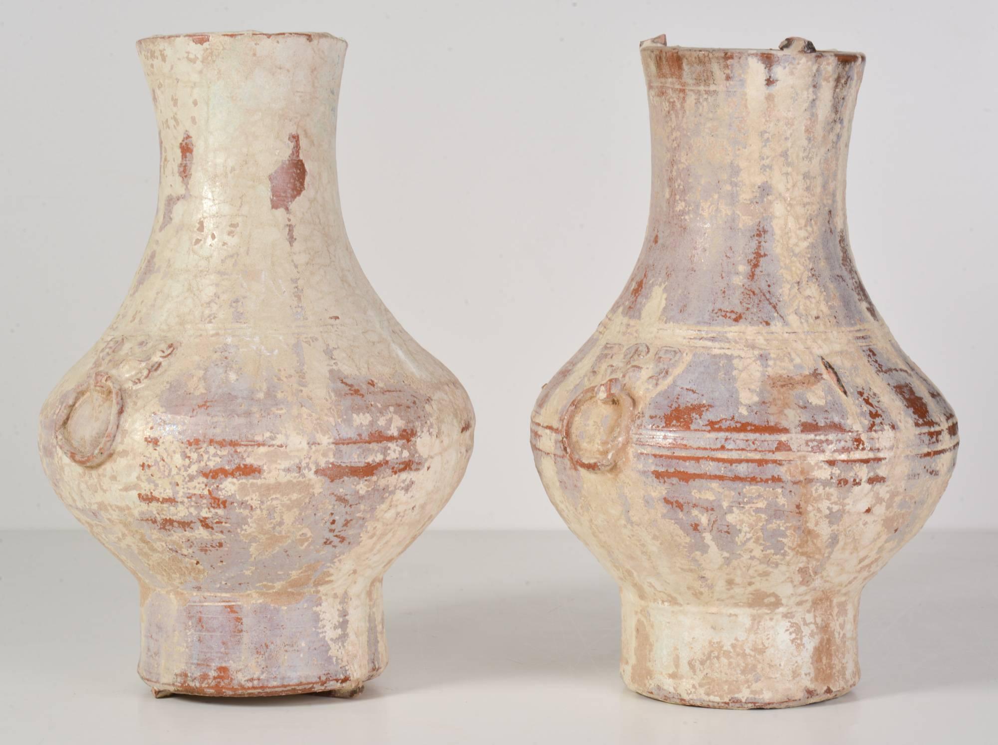 Two Chinese Han dynasty glazed terracotta jars also known as "Hu", meaning jar in Chinese, used for storage of wine, oils and assorted commodities likes grains. 

Green-glazed ware like this dates to the Han dynasty (206 BC to 220 AD)