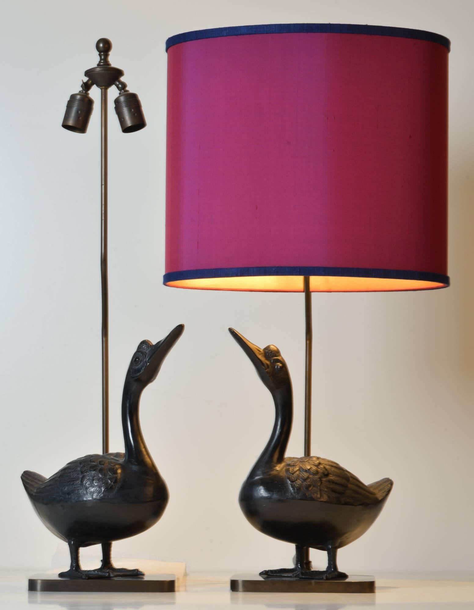 Pair of vintage Chinese bronze goose table lamps. The lamps have a double socket and have new wiring with on-off pull switches. With pair of high-end custom-made linen shades by Rene Houben.

Beautifully cast and finely detailed down to the last