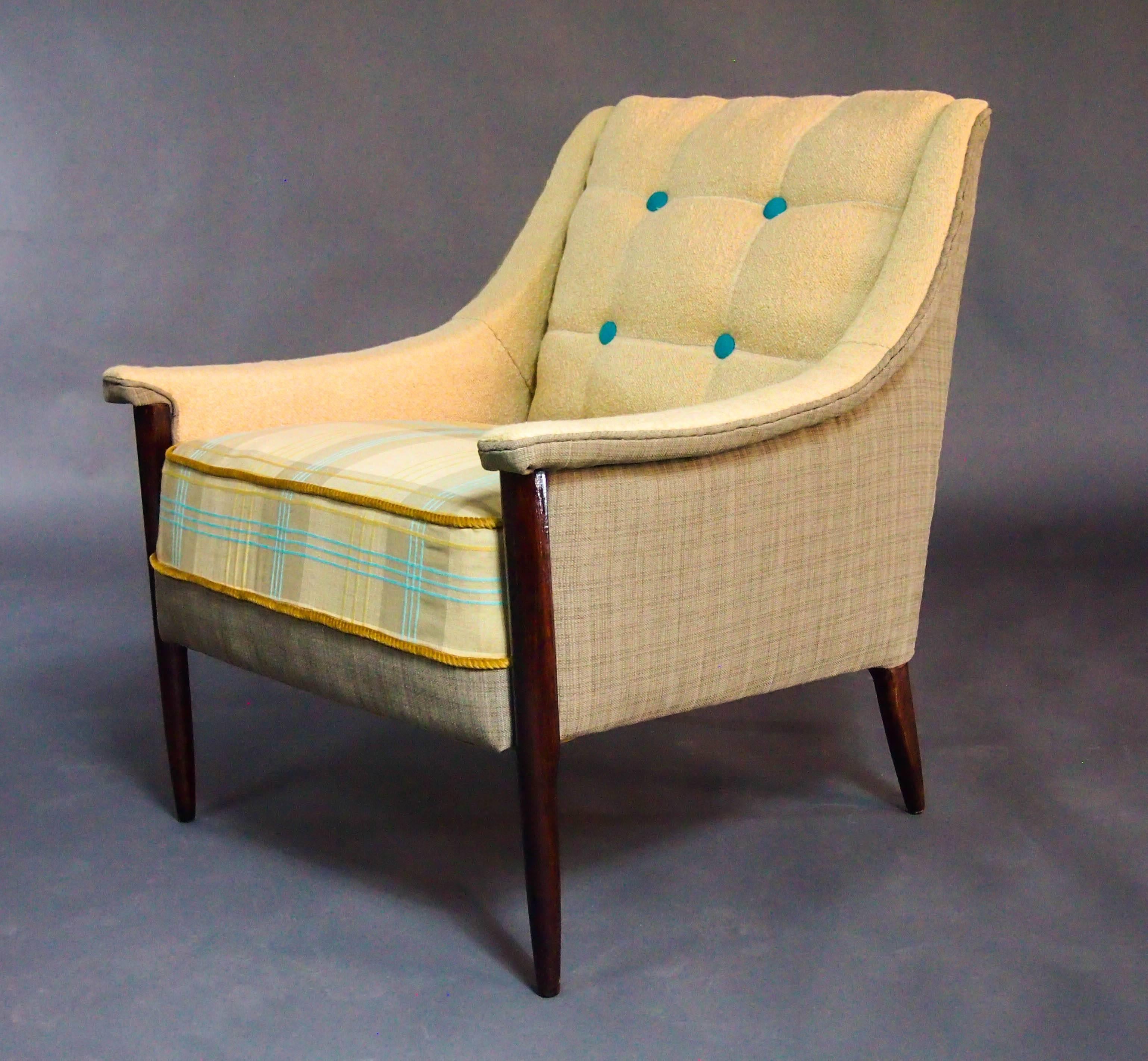 A delicate Kroehler frame from the mid-1950s in the Folke Ohlssen DUX style, stripped bare and given new life. Two subtle plaids and cream colored inside back make this chair simply sophisticated and texture and accenting buttons add interest.