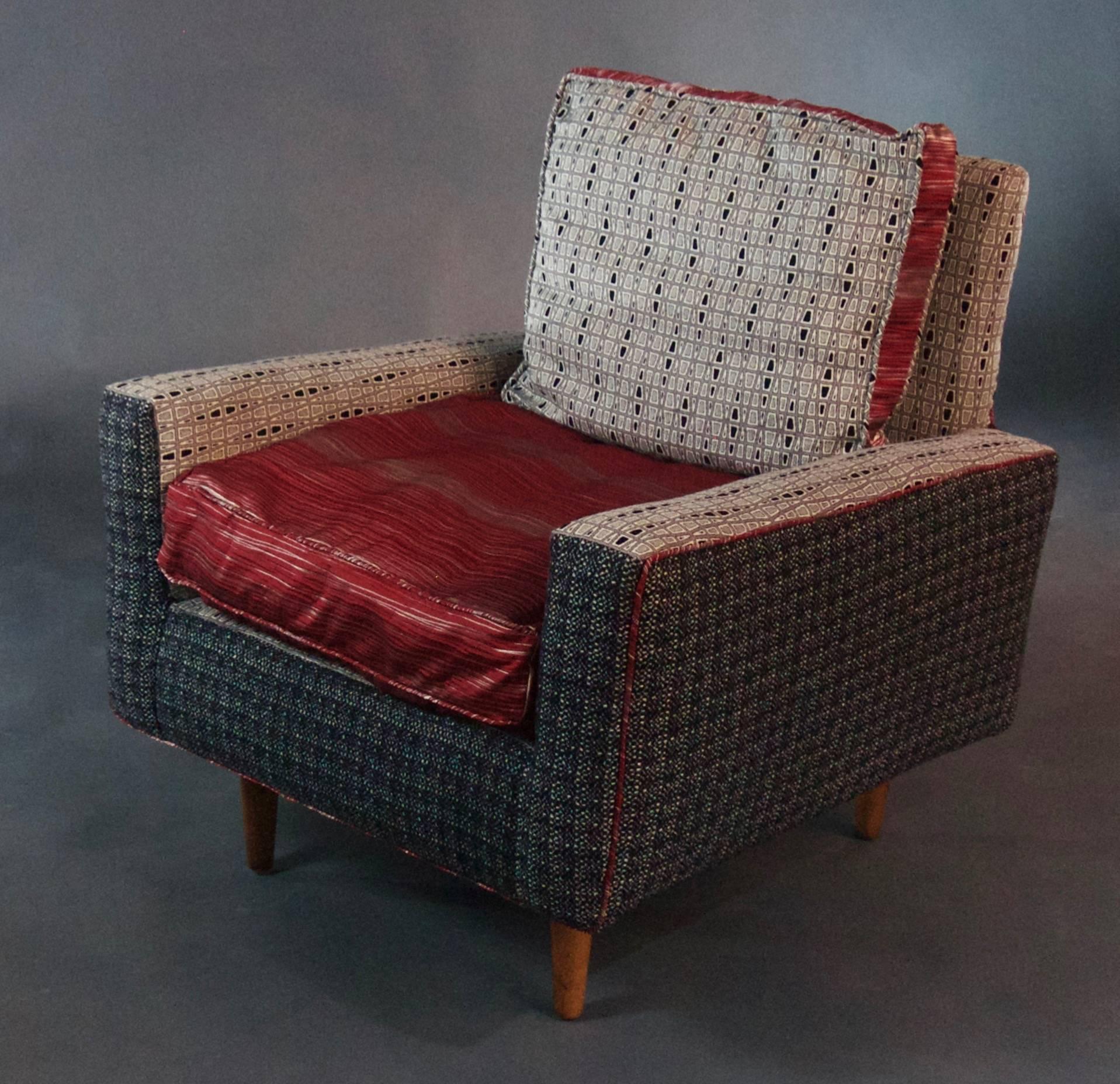 A labelled Knoll armchair with down cushions and Classic cotton fill, under new upholstery. Upholstery is a charcoal gray wool flannel outside, combined with a modern soft white and charcoal print inside--both accented by a red silk blend. This