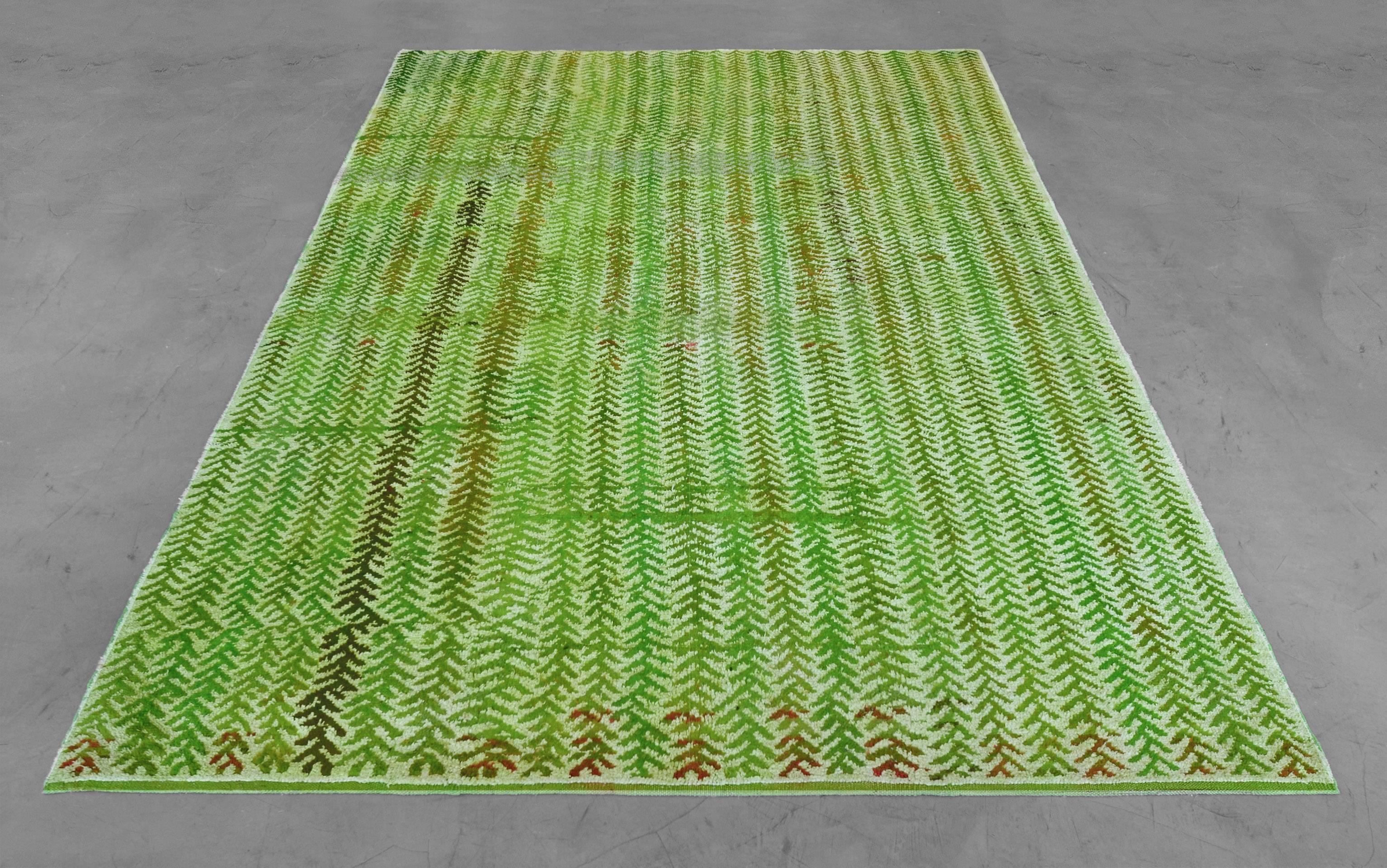 Vintage silk and hemp rug from the late 20th century, hand-knotted in Turkey. This 6’7 x 9’3 rug has brilliant color and unmatched texture with its bright green background with a tonal organic striped motif and juxtaposition of lush soft silk and