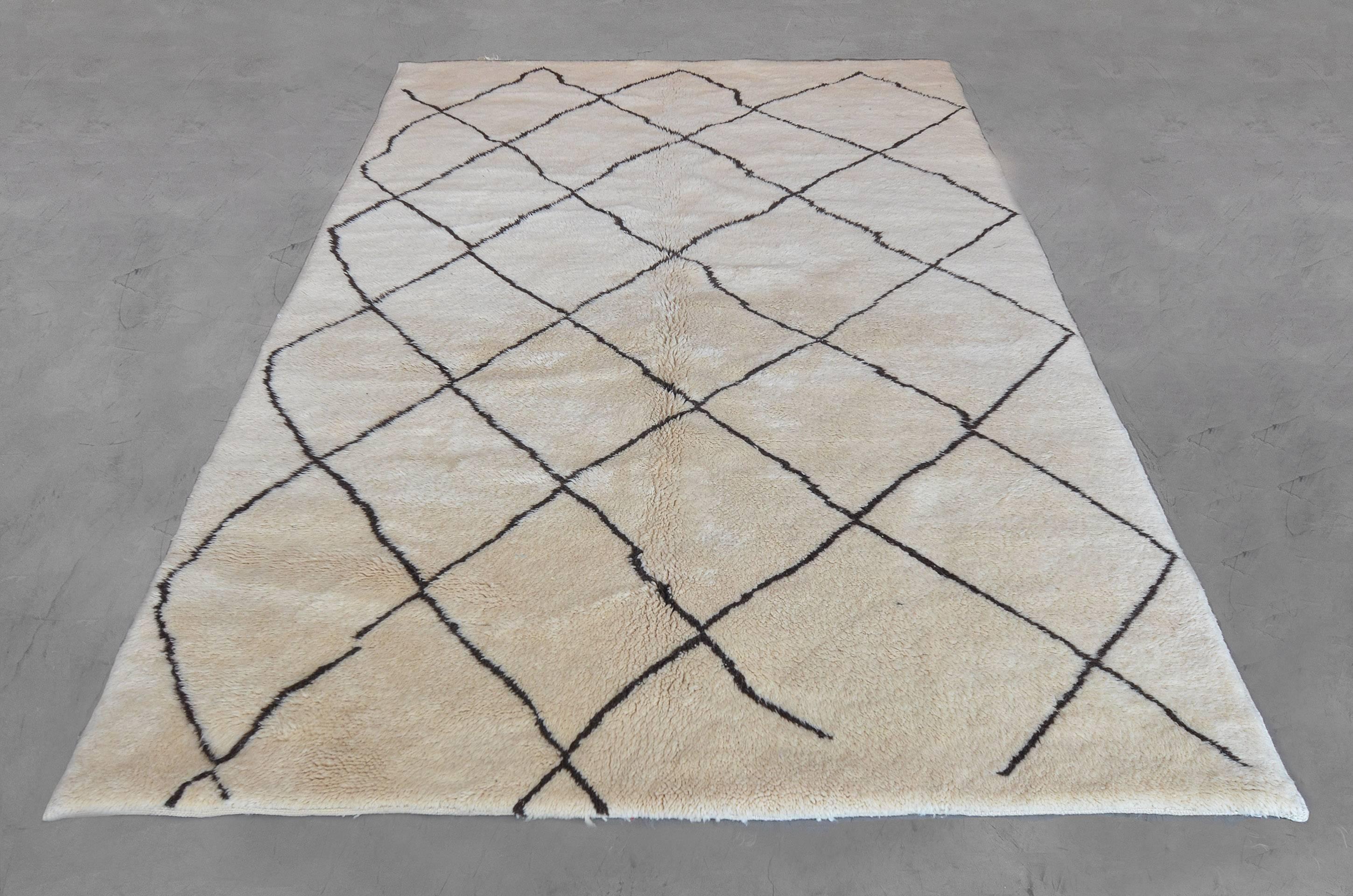 This Deco-inspired rug from the late 20th century is hand knotted in Morocco with a pared down latticework design on a soft neutral beige field. Sized at 6’4” x 9’ this ageless and versatile rug creates unlimited opportunity for any space