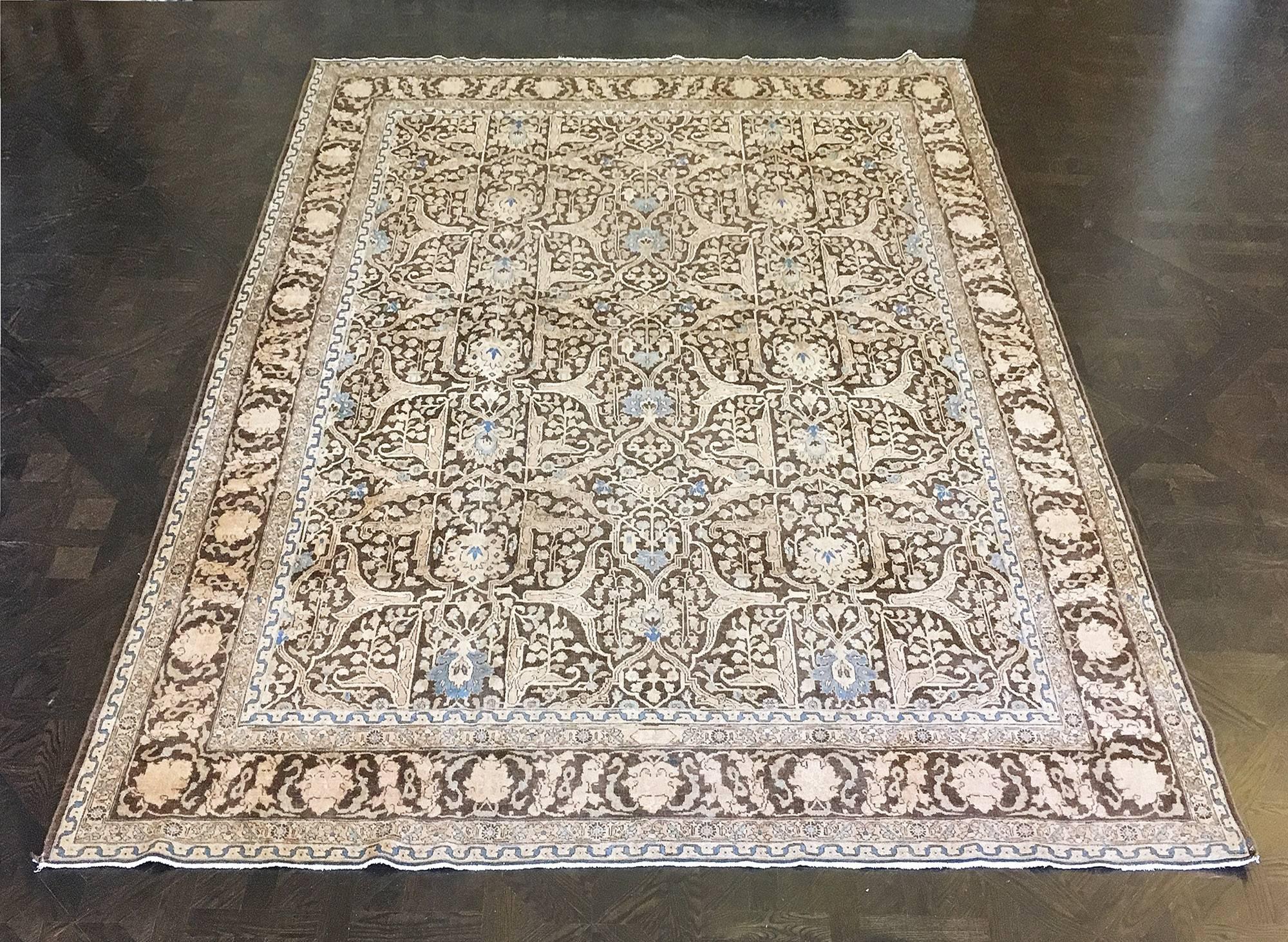 This traditional handwoven Persian Tabriz rug has a deep mahogany field with overall ornate Garrus design, in a mahogany meandering palmette border, between elegant vine and geometric stripes.