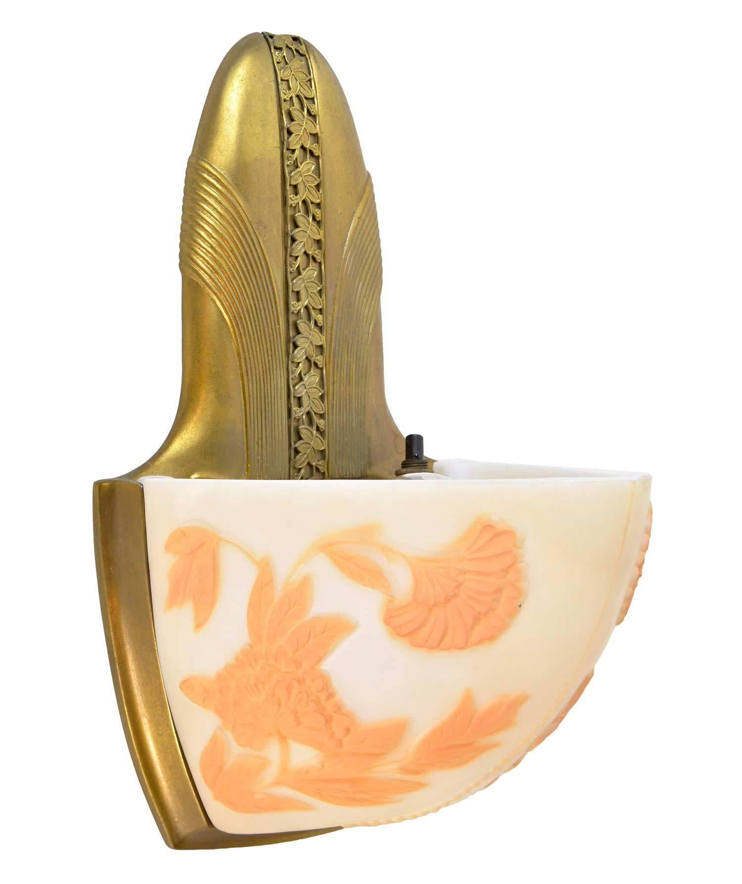 This set of sconces was made by a partnership between two early American lighting companies, Moe Bridges and Consolidated Lighting Co., in the late 1920s. Consolidated glass created a cameo glass shade with tones of cream and peach. Moe Bridges