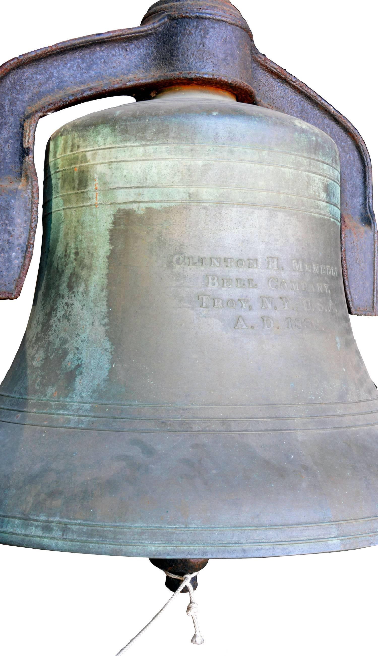 A solid bronze bell manufactured by Clinton H. Meneely Bell Company in Troy, New York. The lovely original patina of bronze delivers a melodic sound when rung in the key of B flat. Bell is 32" in diameter and the unit comes complete with its