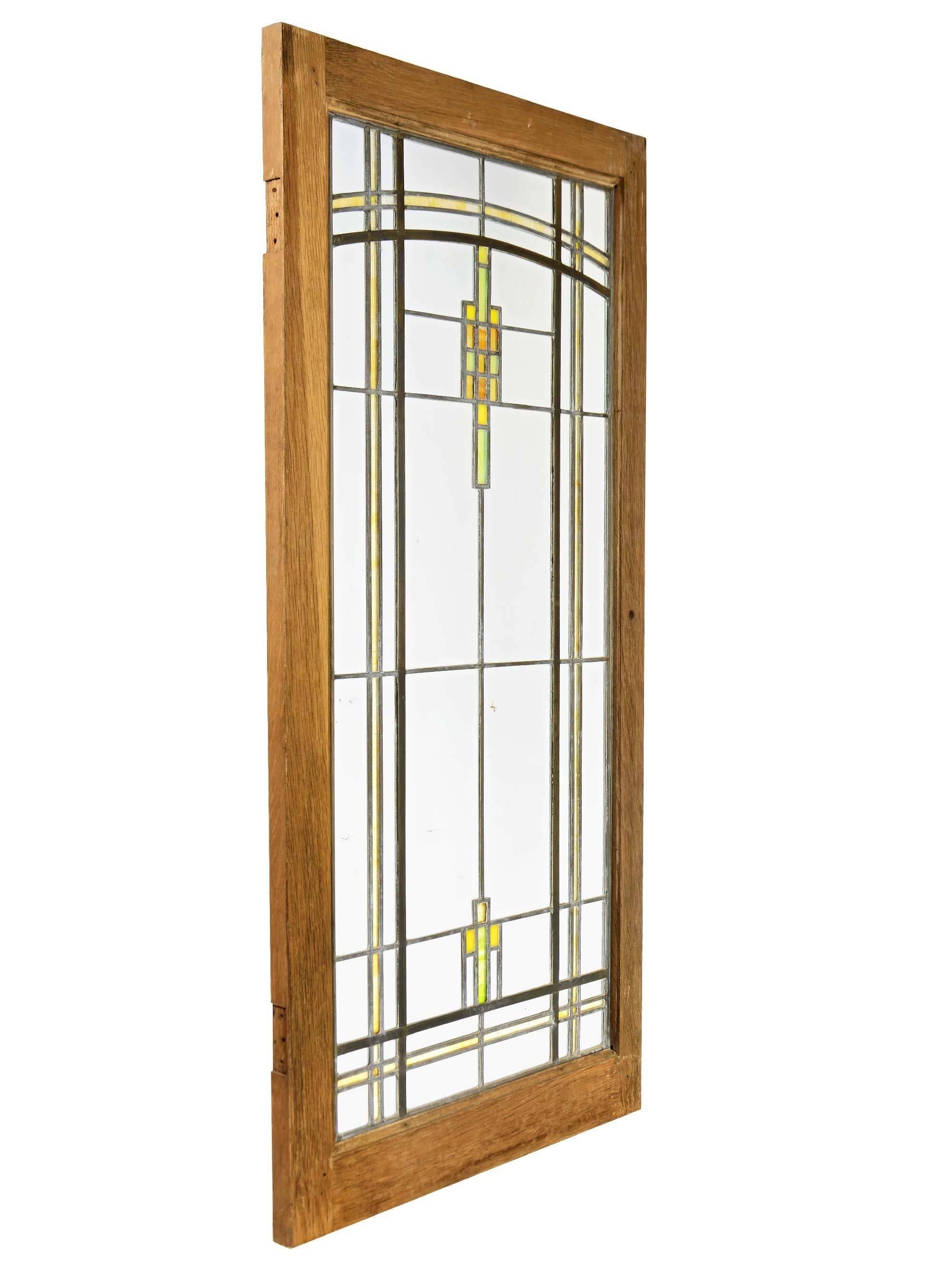 These stunning leaded glass prairie windows feature stylized flowers of yellow, orange and green stained glass. Designed by prominent Prairie School architect George Grant Elmslie.

Finish: Original.
  