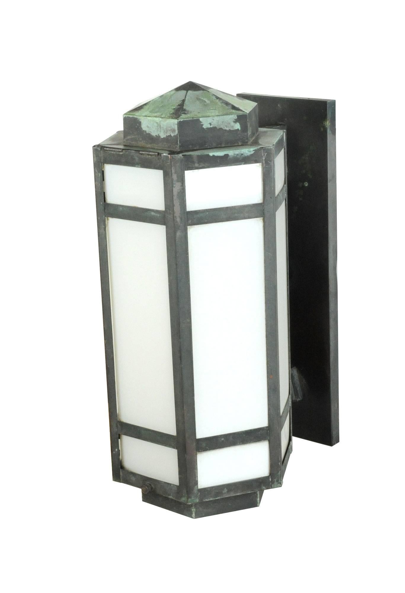 This impressive Art Deco exterior sconce is made with white glass panels and copper that has oxidized beautifully over time. Its hexagonal shape gives it added dimension. 

Contains one medium socket.
           