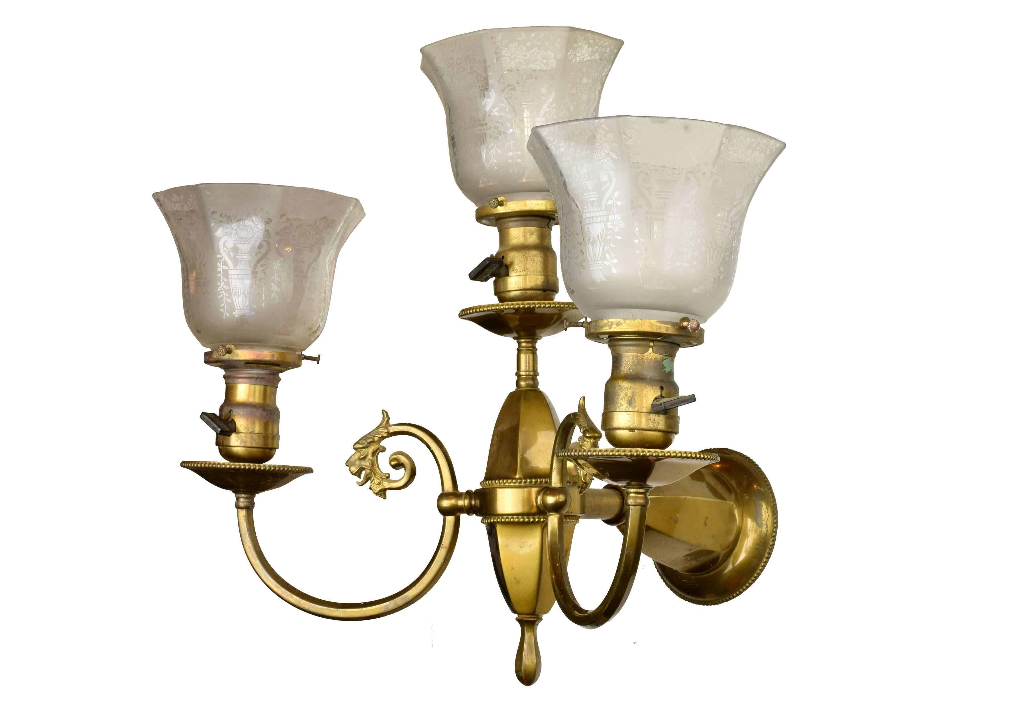 Two griffin heads embellish the elegant, clean lines of this three arm brass sconce from esteemed manufacturer Beardslee. It is truly an exquisite piece, one that will be cherished for years to come. 

Shades included
Three medium sockets

We
