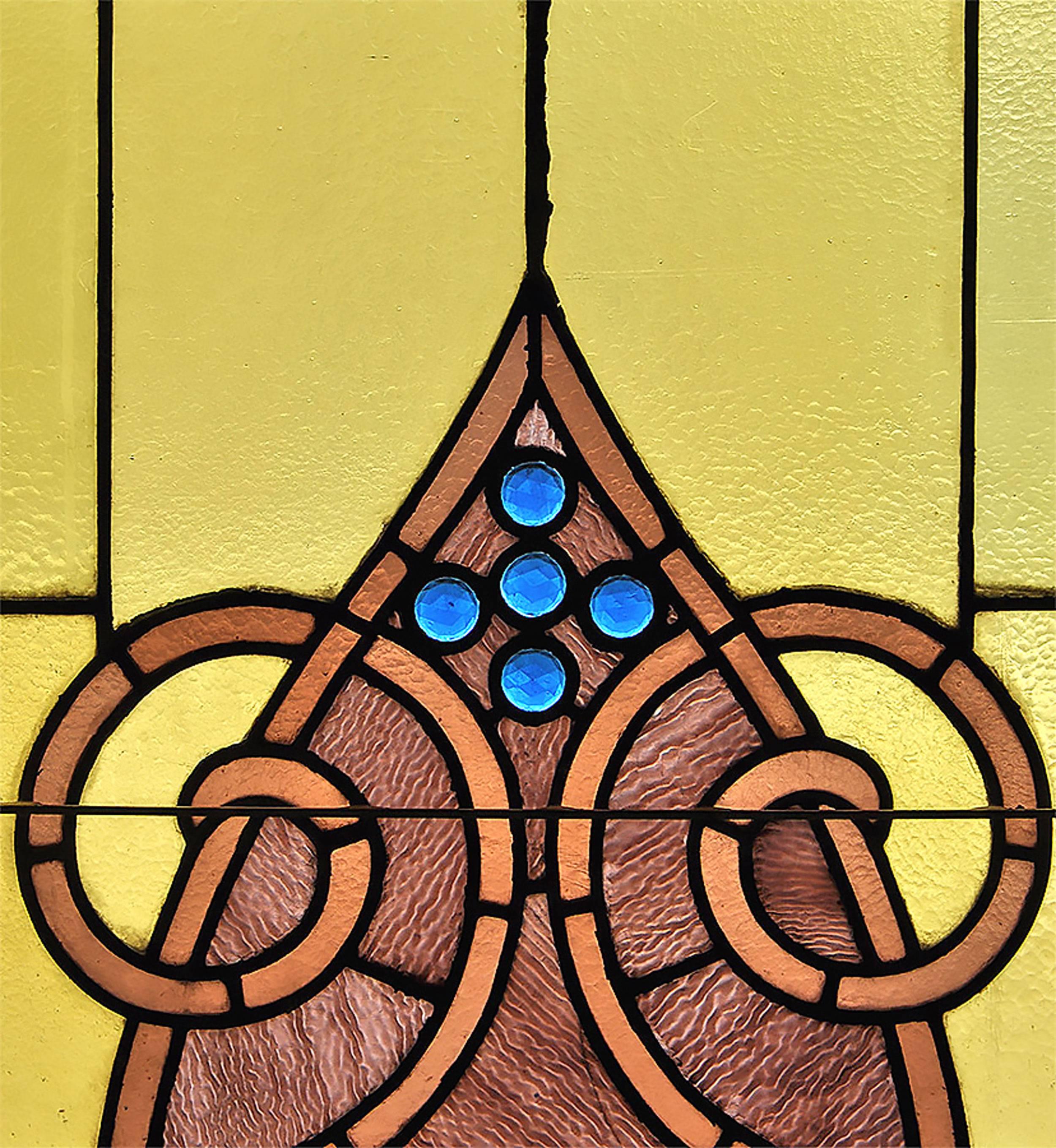 These gorgeous stained glass arched windows shine with a multitude of colors: mottled greens and browns toward the top and bottom compliment the more vibrant turquoise and lavender at the center. Each window was carefully removed from a church in