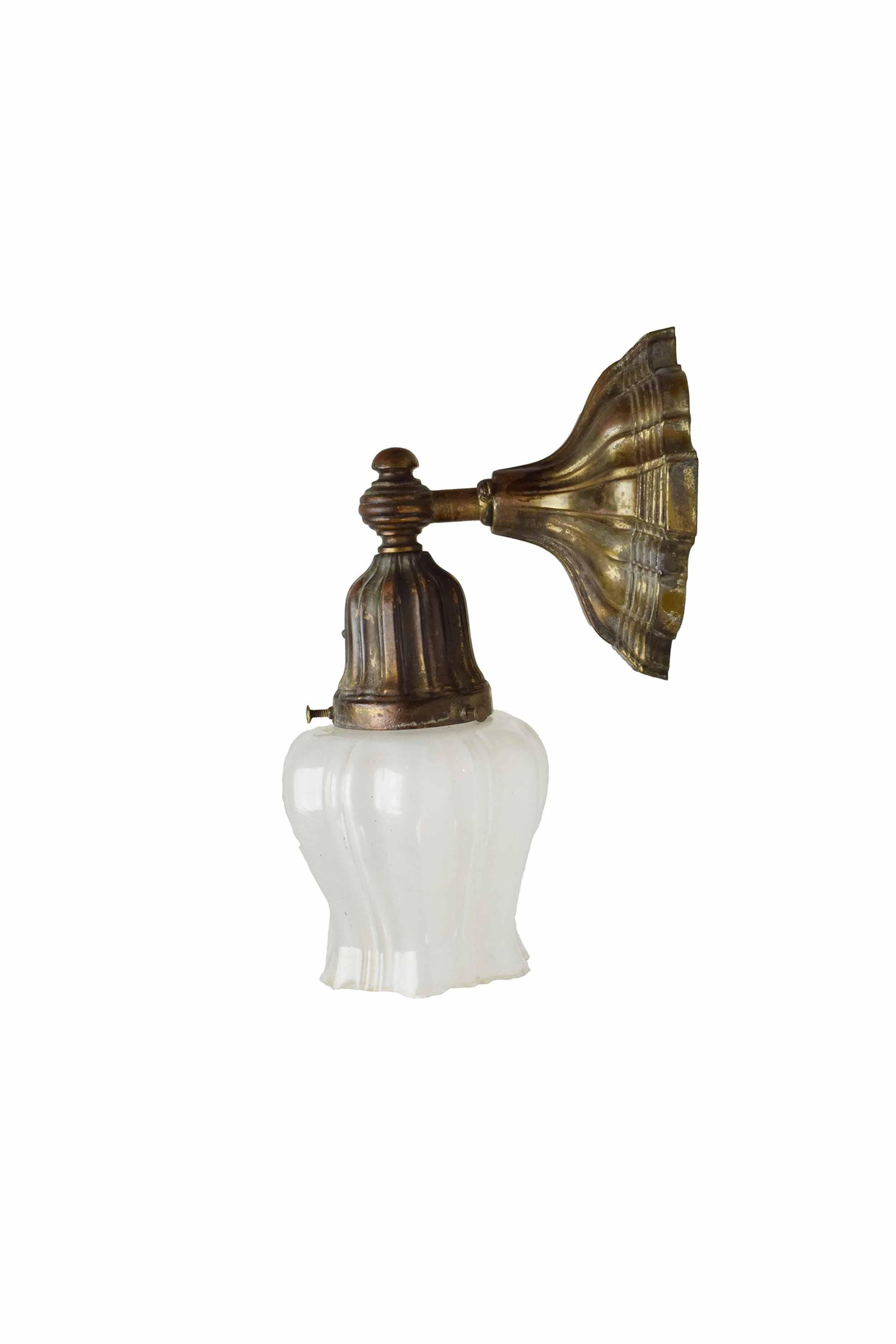 This brass Sheffield sconce will add a sense of wonder to your home! This sconce comes with the beautiful white glass shade pictured. 

Finish: Original
Country of origin: USA
Single intermediate socket

We find that early antique lighting was