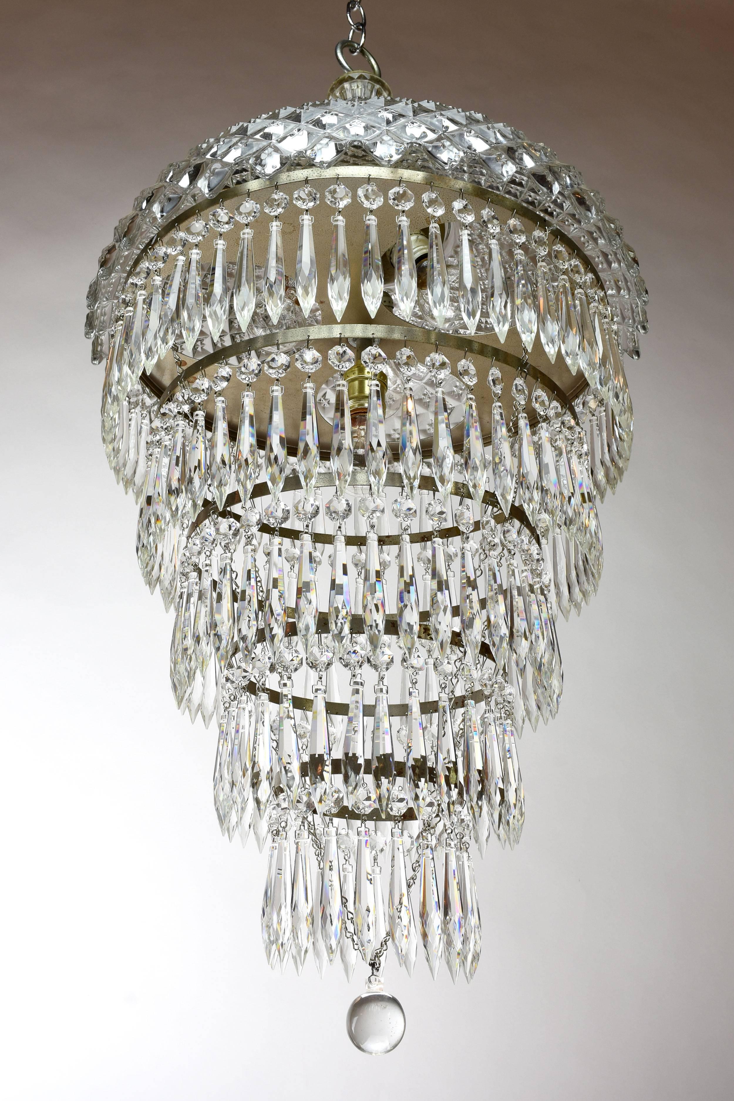 This stunning chandelier features a crystal top and five tiers of dazzling prisms atop a crystal final. This fixture will make an elegant statement piece in any home.

Four medium sockets

We find that early antique lighting was designed as