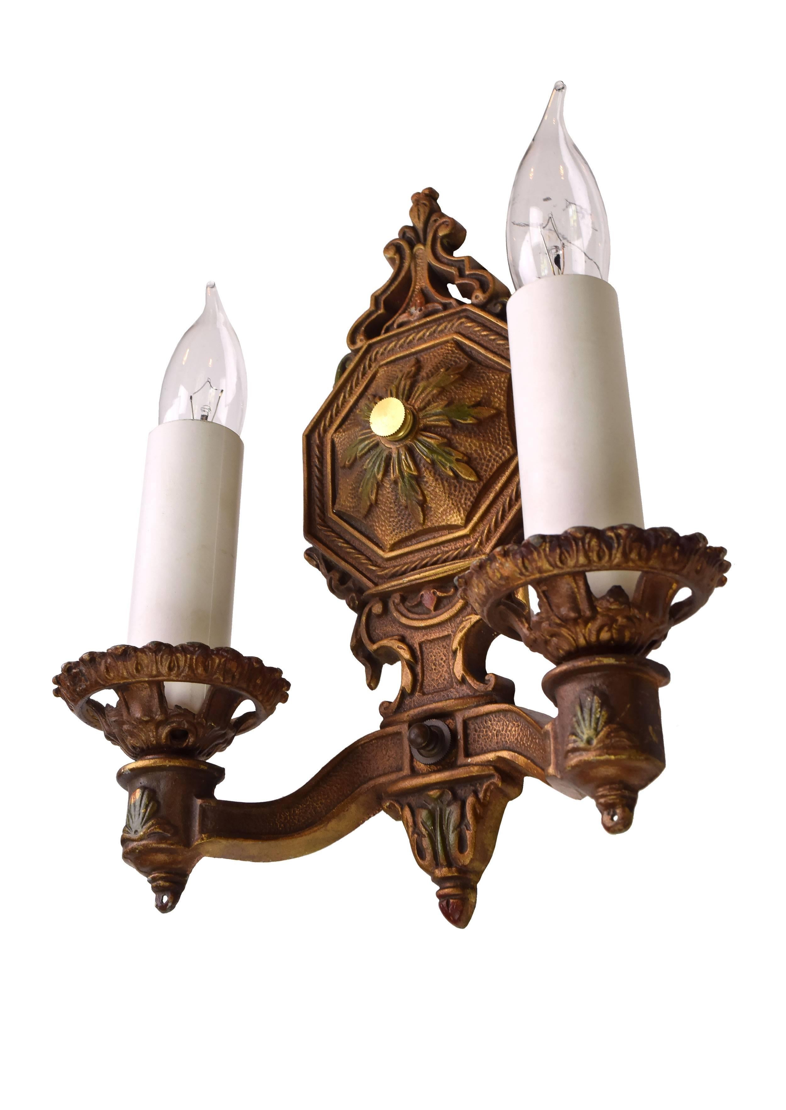 These stunning two-arm aluminium sconces have a beautiful coppery finish with subtle red and green details. Hammered metal and organic ornamentation add interest to each fixture. 

Two medium sockets

We find that early antique lighting was
