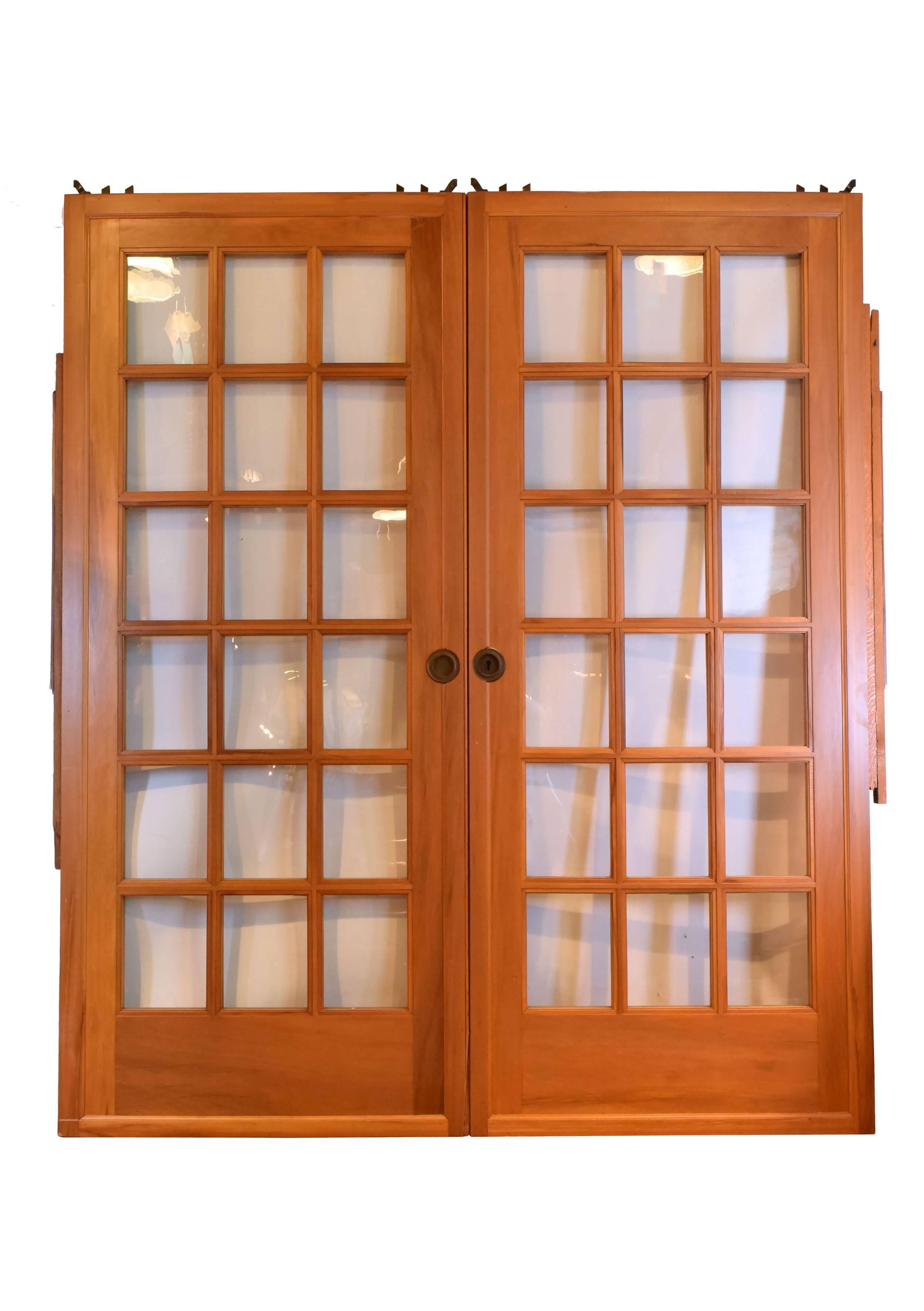 This stunning full-view pocket door set comes complete with jamb, trim and naturally aged brass hardware. Latticework adds interest to this beautiful door that's perfect for a small space, 

circa 1920
Finish: Original
Country of origin: