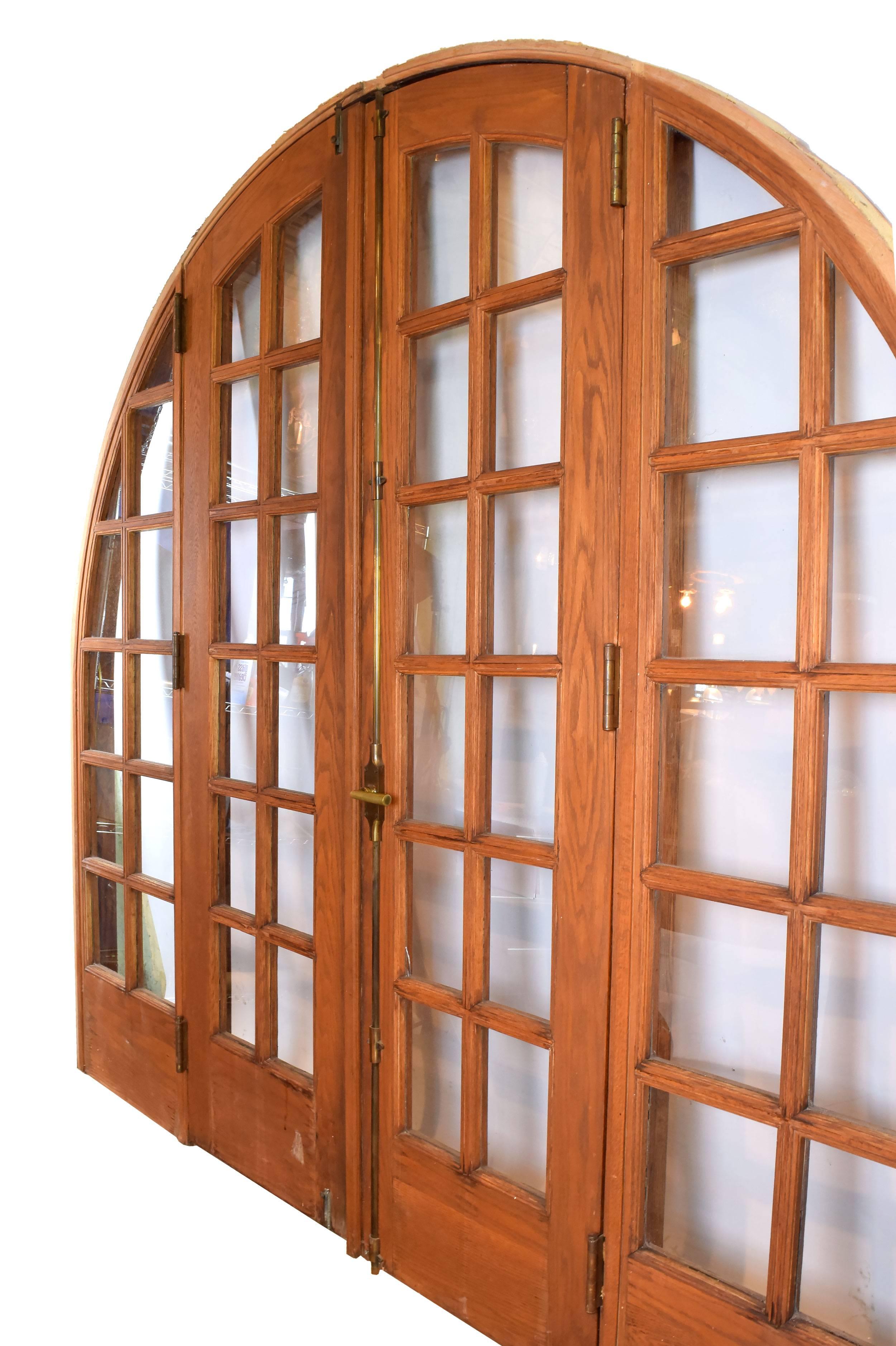 This arched oak door unit would make an impressive focal point in any room, whose elegant curving edges are juxtaposed beautifully with geometric latticework throughout. Another wonderful feature of this piece is the Cremone bolt, which runs