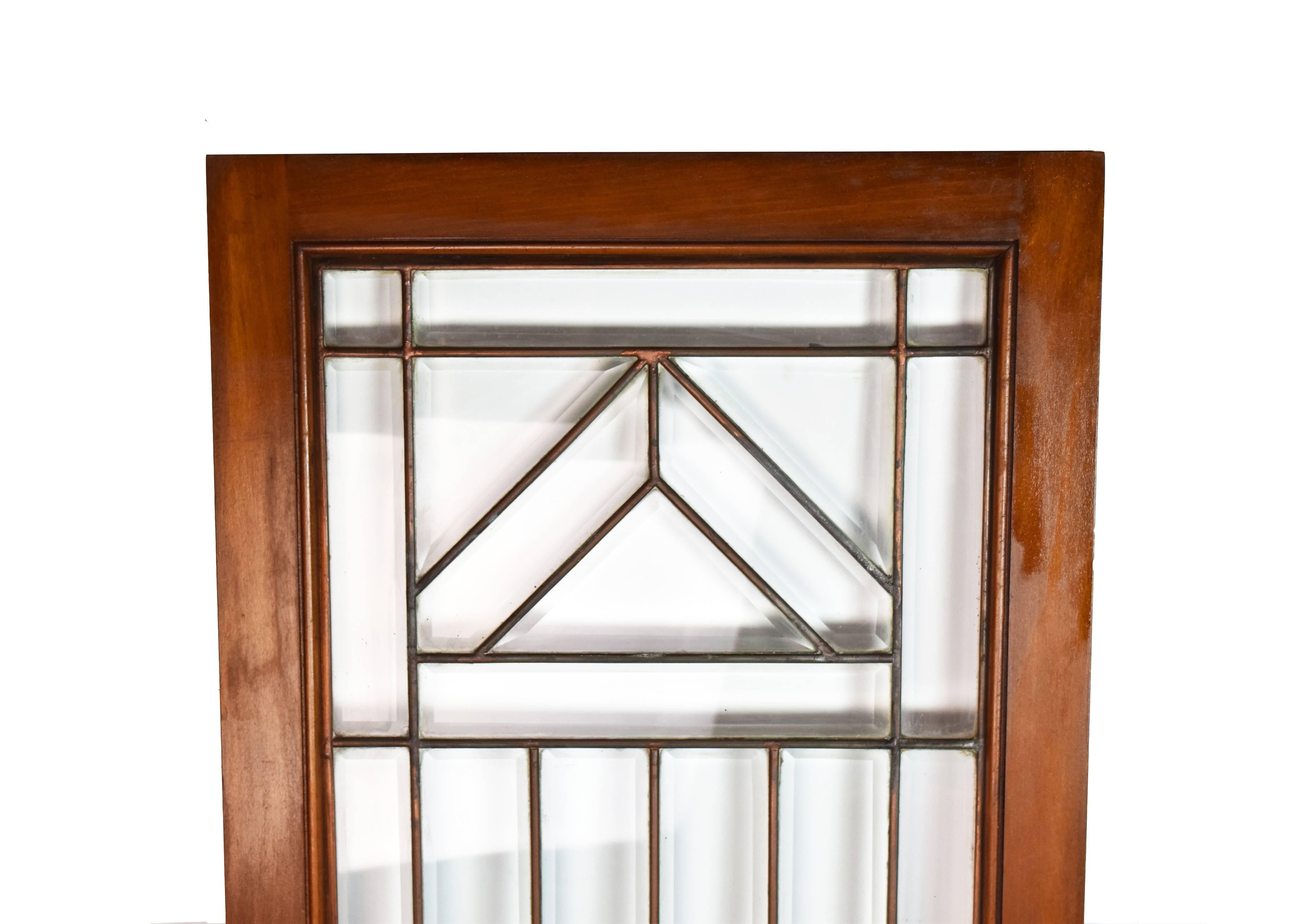 These beautifully simple and elegant Arts & Crafts style beveled cabinet doors have a beautiful wood frame with geometric glasswork. There are two matching doors available in this size.