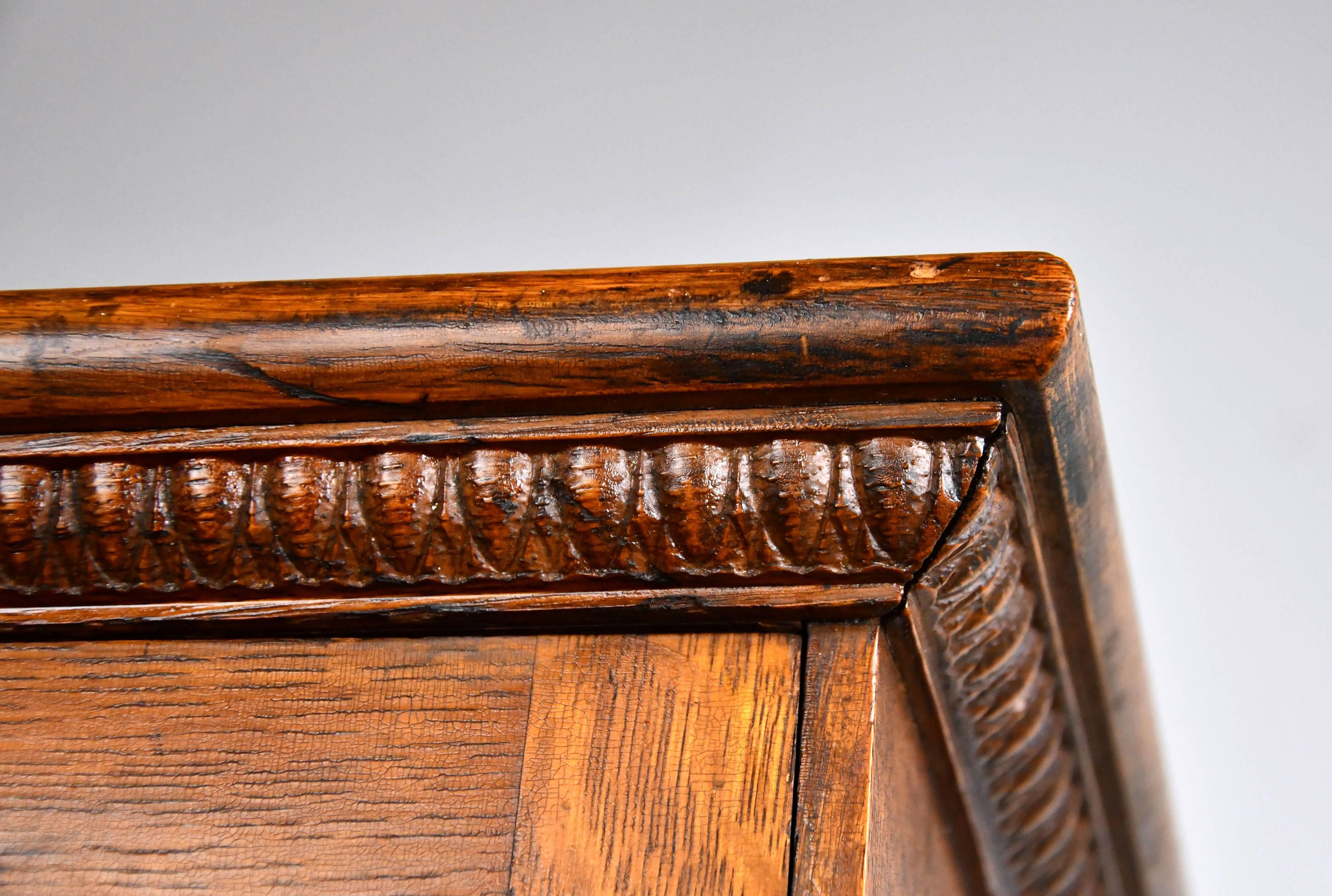 The simple design and rich woodwork are the highlights of this quartersawn oak display case. Egg and dart details around the top, and beveled woodwork around each pane of glass add further interest to this beautiful fixture.