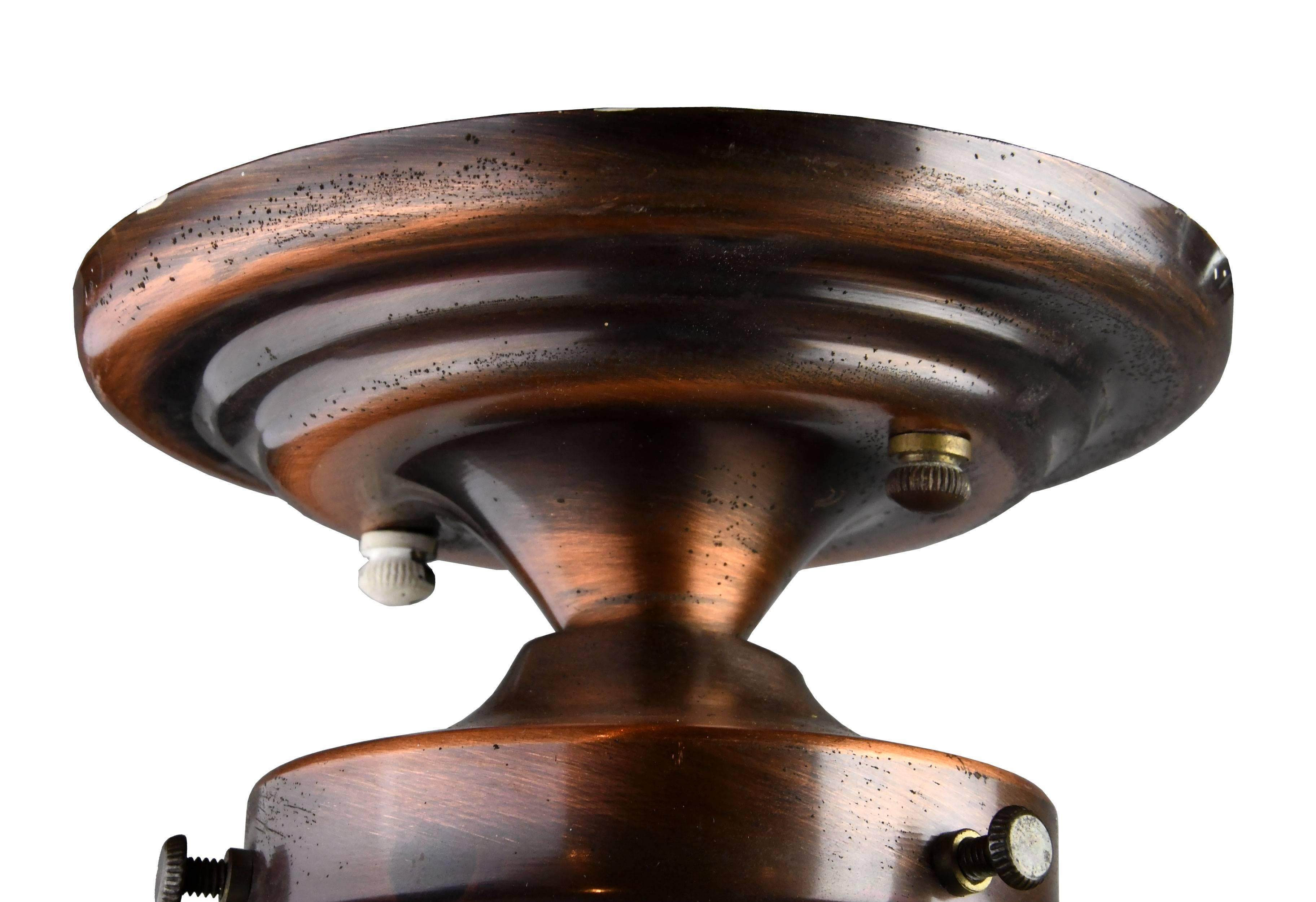 This darling midcentury copper exterior flush mount features a white globe and 