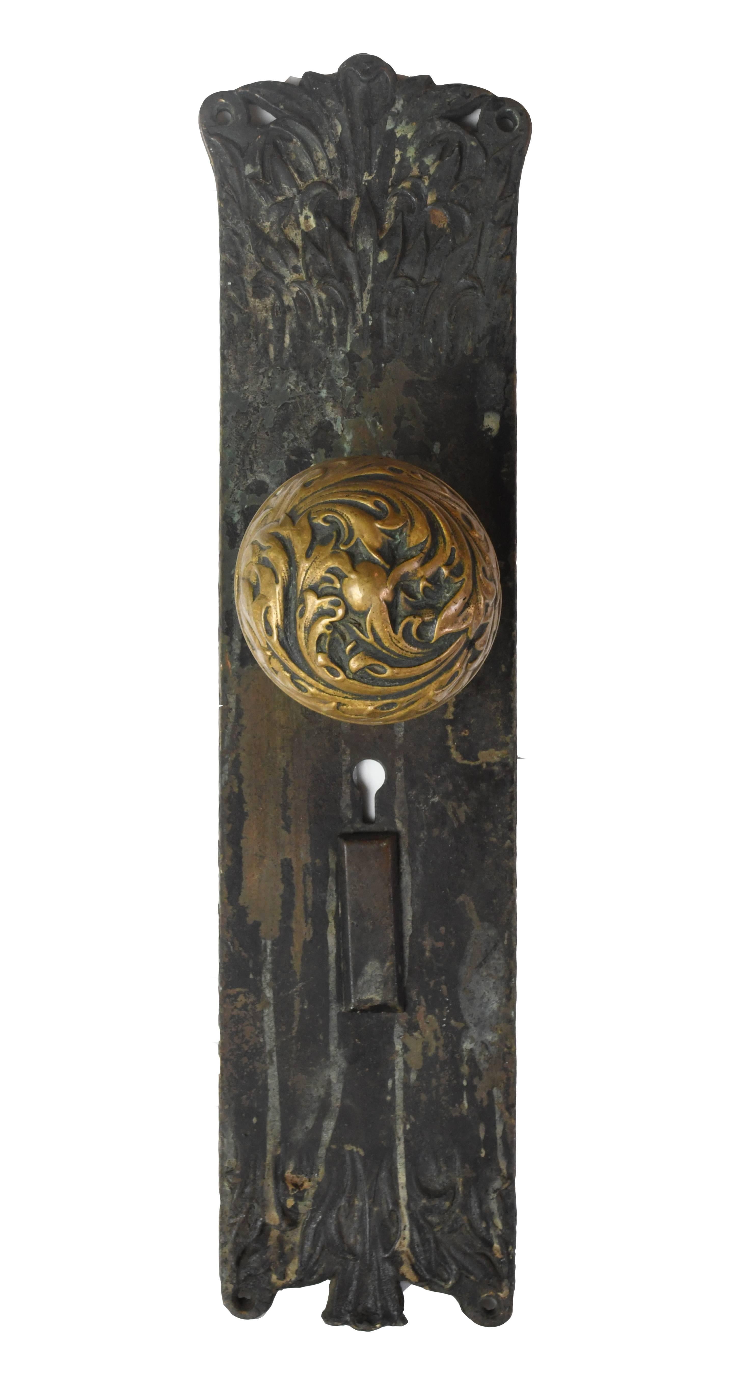 Gorgeous cast brass door hardware set made by Corbin, one of the great early American hardware manufacturers. The 'Florence' pattern is ornate, organic and textural. Set comes with two door knobs, smaller interior door plate and larger exterior door