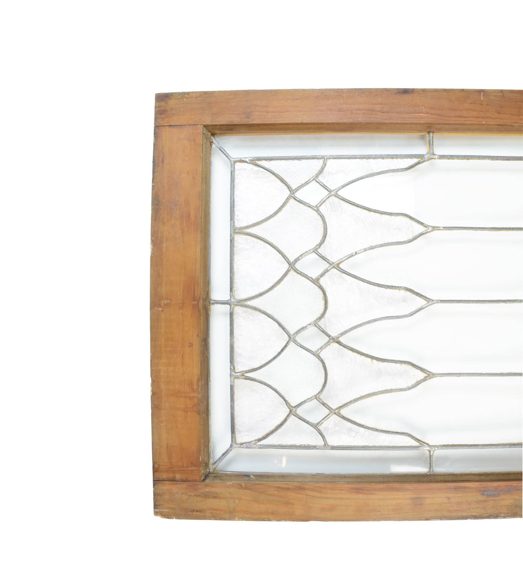 This beautiful Victorian transom leaded glass window features clear jewels, and an ornate inter-looping pattern. Because the patterns are geometric, it could also work vertically.